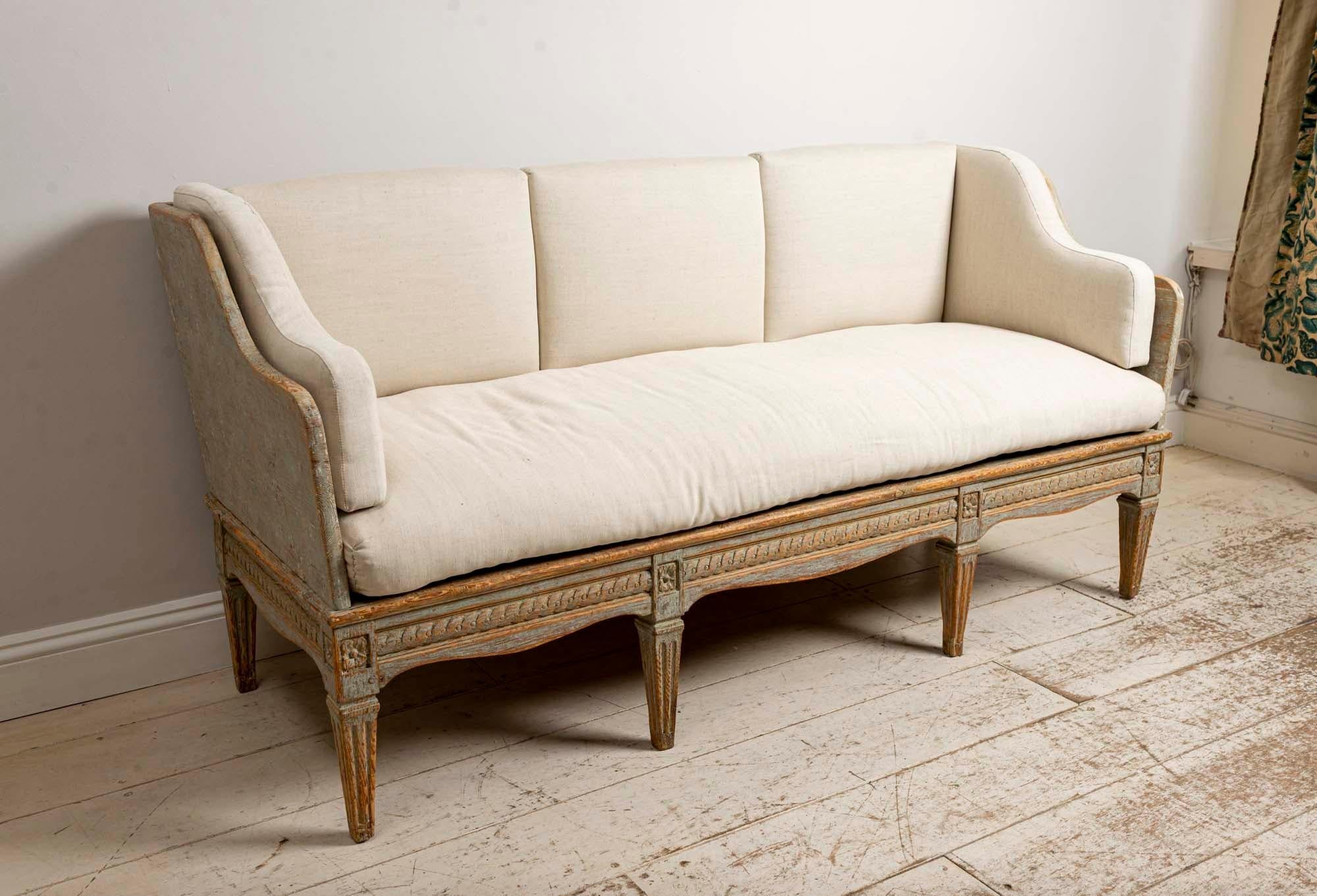 19th century Swedish Gustavian Trag sofa, with a wonderfully decorated front frieze 
Upholstered in a neutral linen fabric.
The sofa is extremely comfortable and can be used in the centre of the room or against a wall. 
In very good condition.