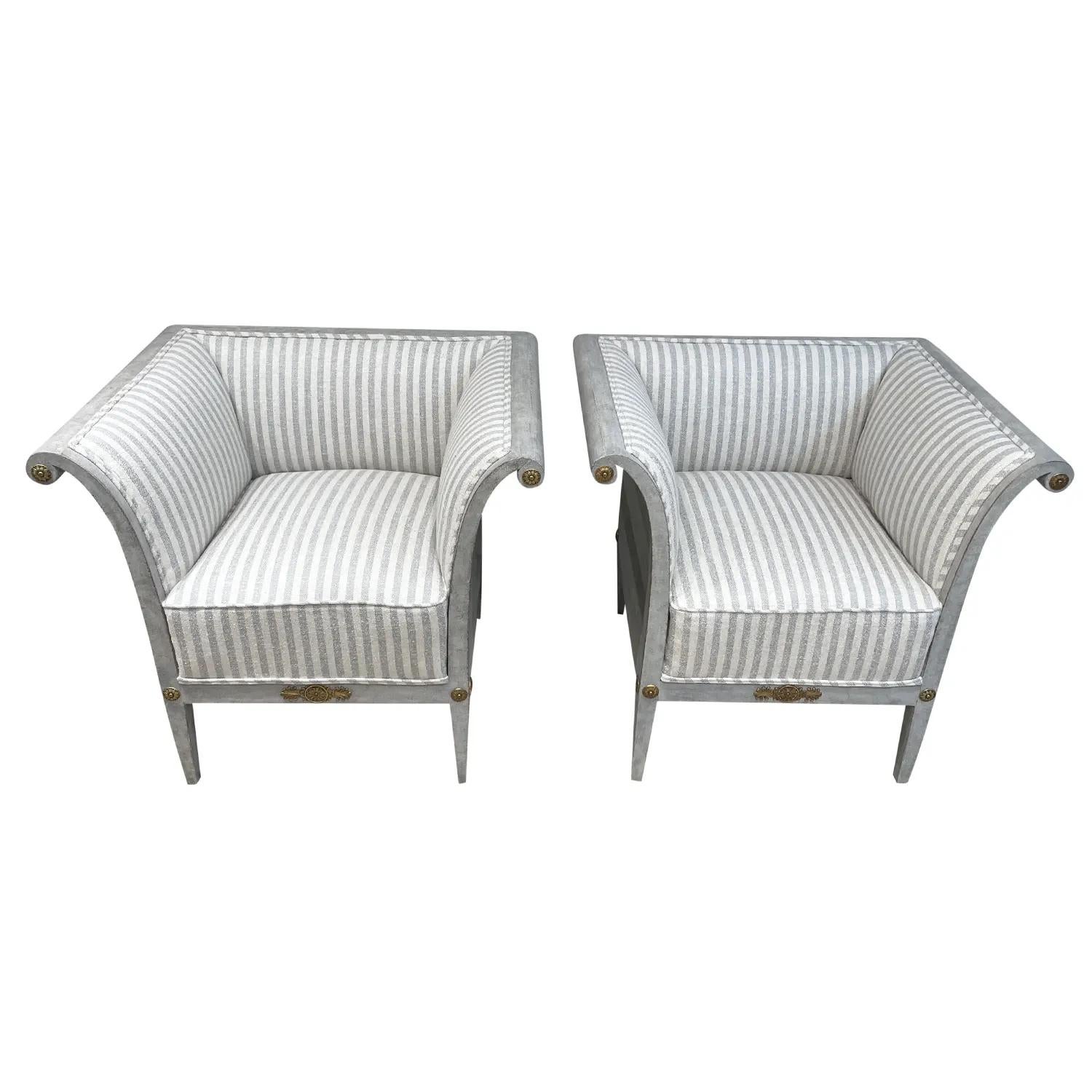 A light-grey, antique pair of armchairs made of hand carved Pinewood with brass detailing. The Scandinavian side chairs are detailed in the Neoclassical Greek style, in good condition. Newly upholstered in a light-blue, white cotton fabric. Wear