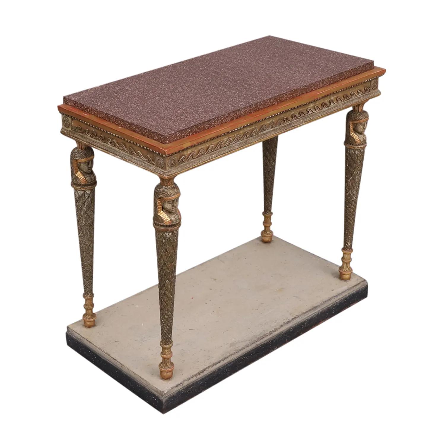 A gold, antique Swedish Gustavian freestanding console table made of hand crafted gilded, painted Pinewood in the Egyptian style with a crystal red porphyry top, designed and produced most likely by Jonas Frisk in good condition. The edges, borders