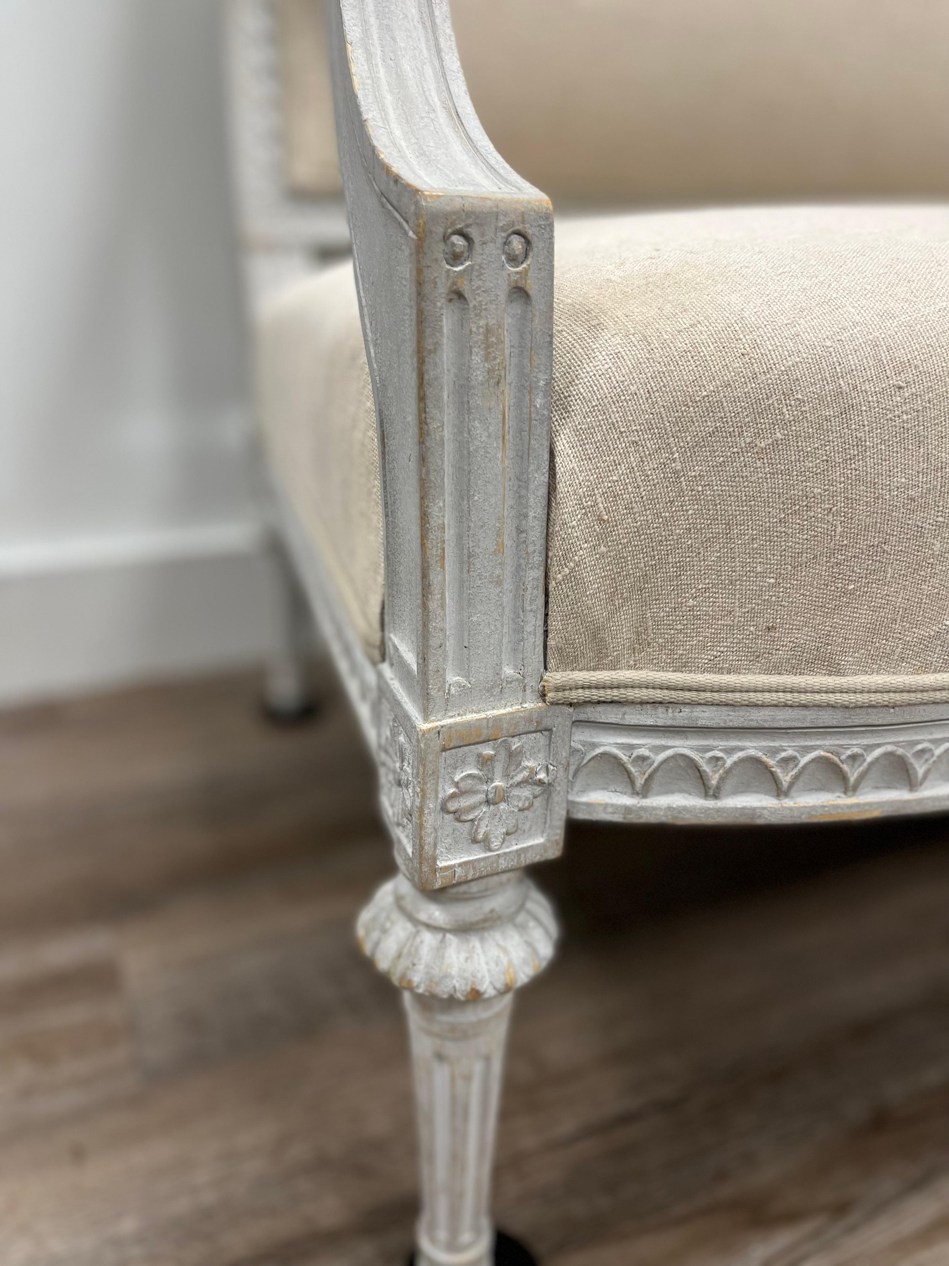 A sizable Swedish Late Gustavian sofa made in Stockholm by master furniture maker Ephraim Stahl (active 1794-1820). Signed ES on a back leg. Frames and sashes are decorated with upright leaves, also known as leaf cut. The front and side edges meet