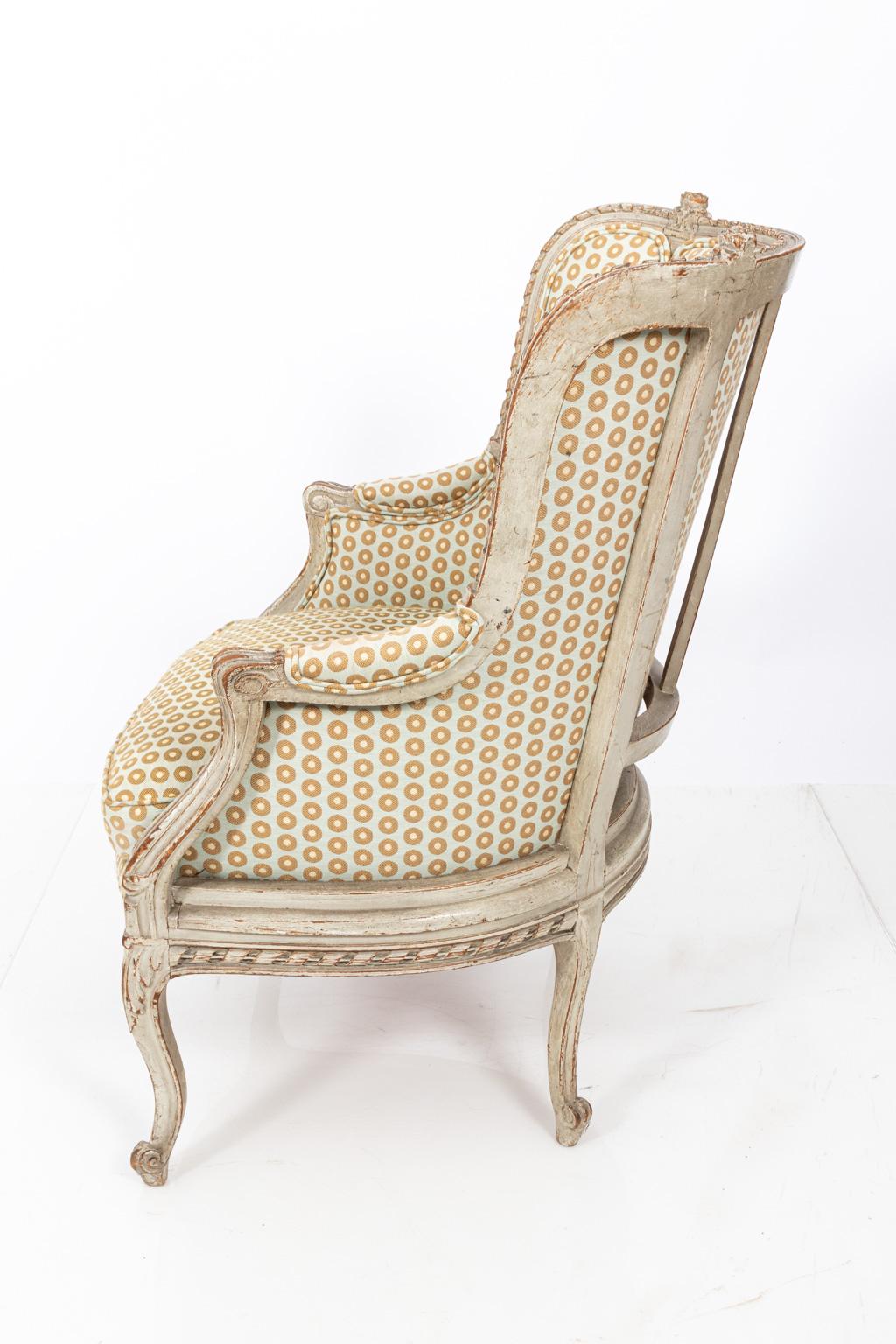 Swedish Gustavian style bergère armchair with distressed finish and tub back surrounded by carved flowers. Please note of wear consistent with age, circa 19th century.