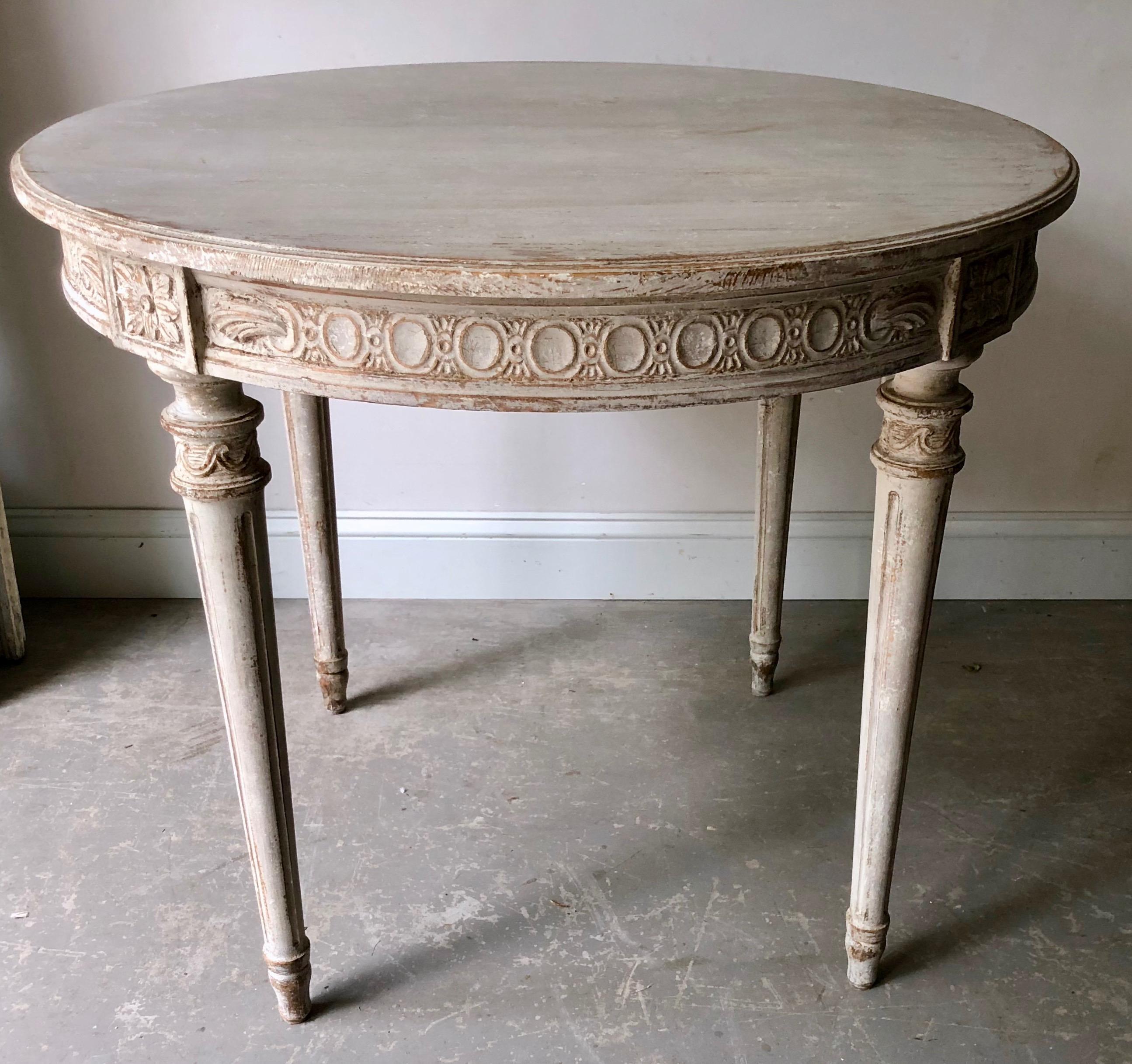 Swedish Gustavian style centre table with richly carved apron and tapering reeded and carved legs with Stockholm, Sweden, circa 1880.