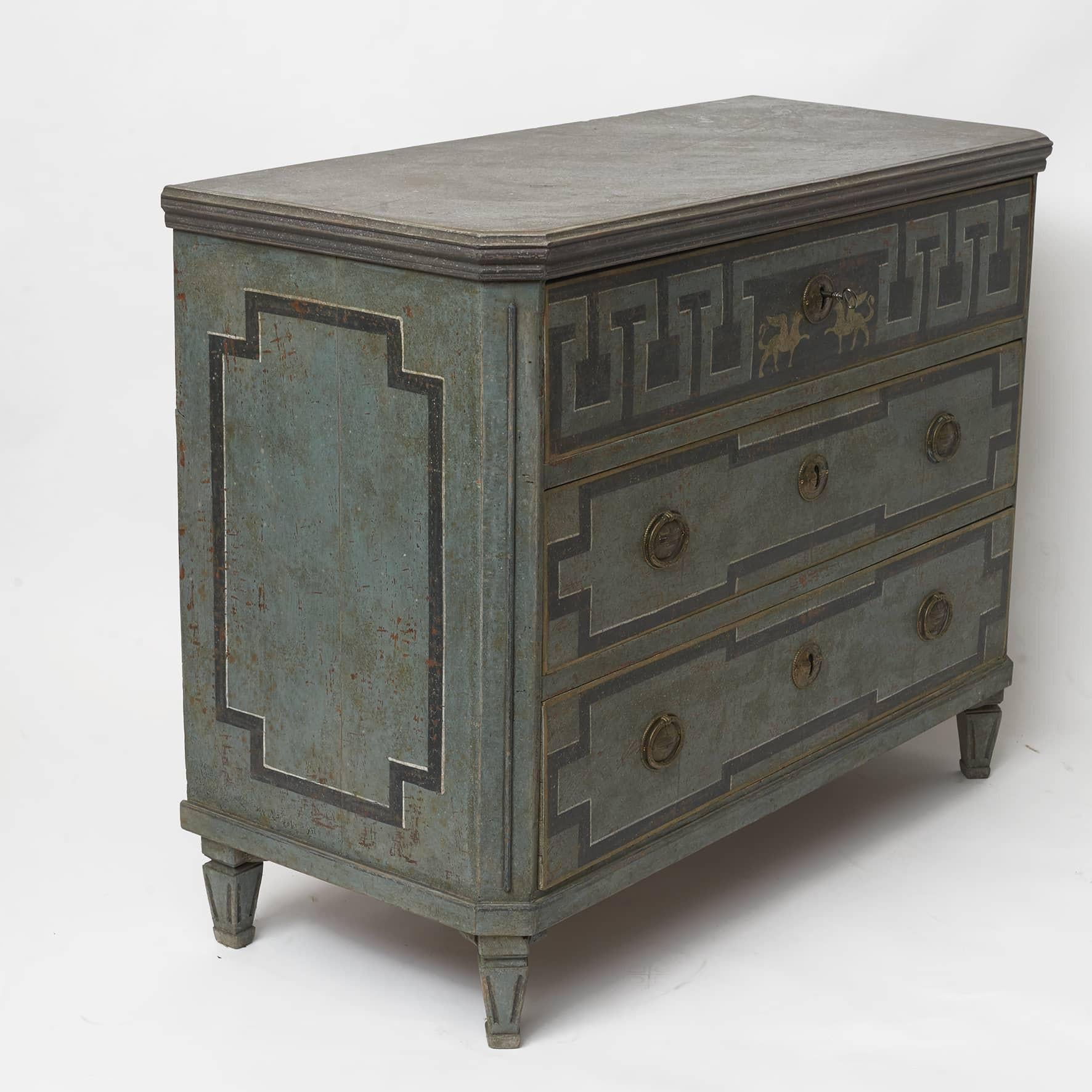 Swedish Gustavian style chest of drawers painted in blue shades. Faux porphyry painted top and moulded edge above three drawer. Upper drawer decorated with 