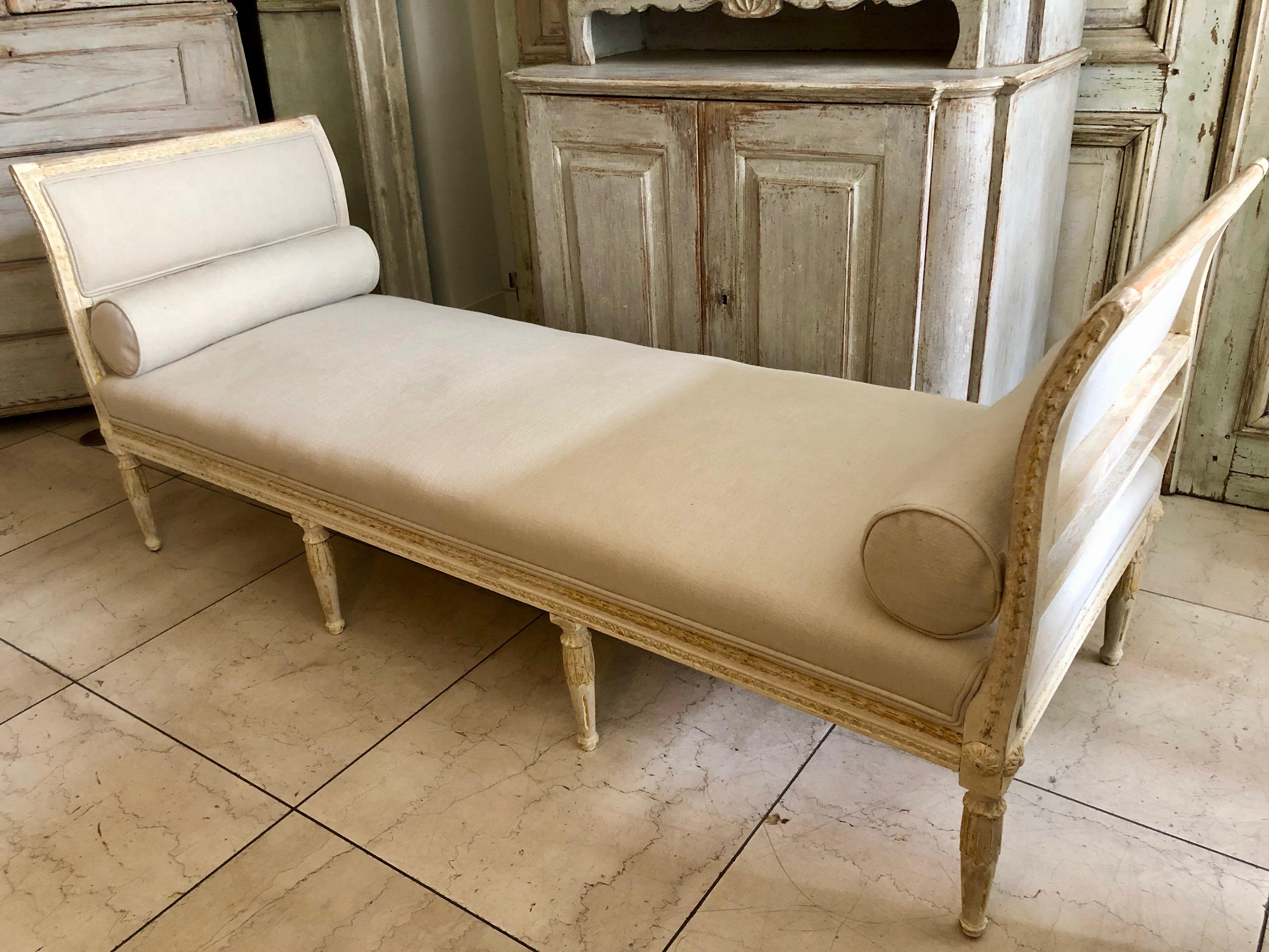 A richly carved Swedish Settee/Daybed. Hand-scraped back to its original cream-white paint and upholstered in linen. 
Sweden, circa 1860. 
      
      