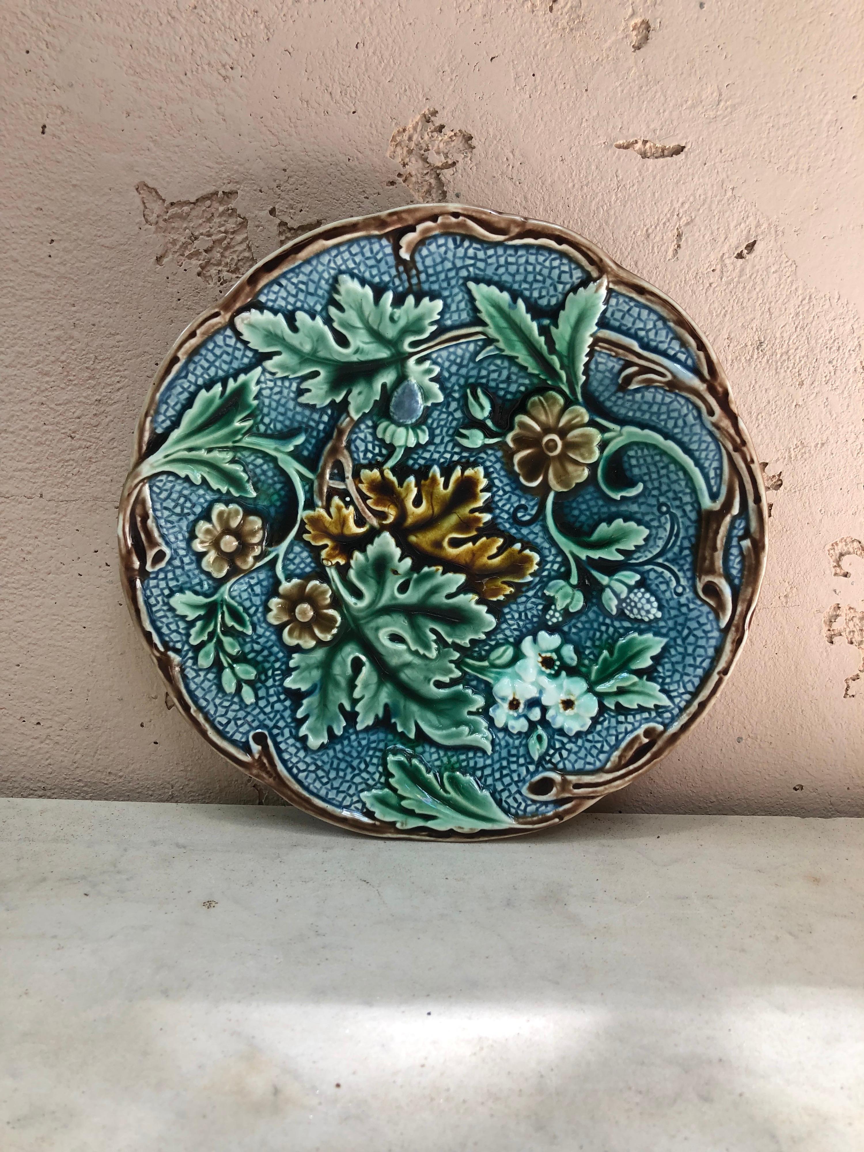 Swedish Majolica dessert plate signed Rörstrand, circa 1897. 
Decorated with flowers on a blue background, branches on the border.
 