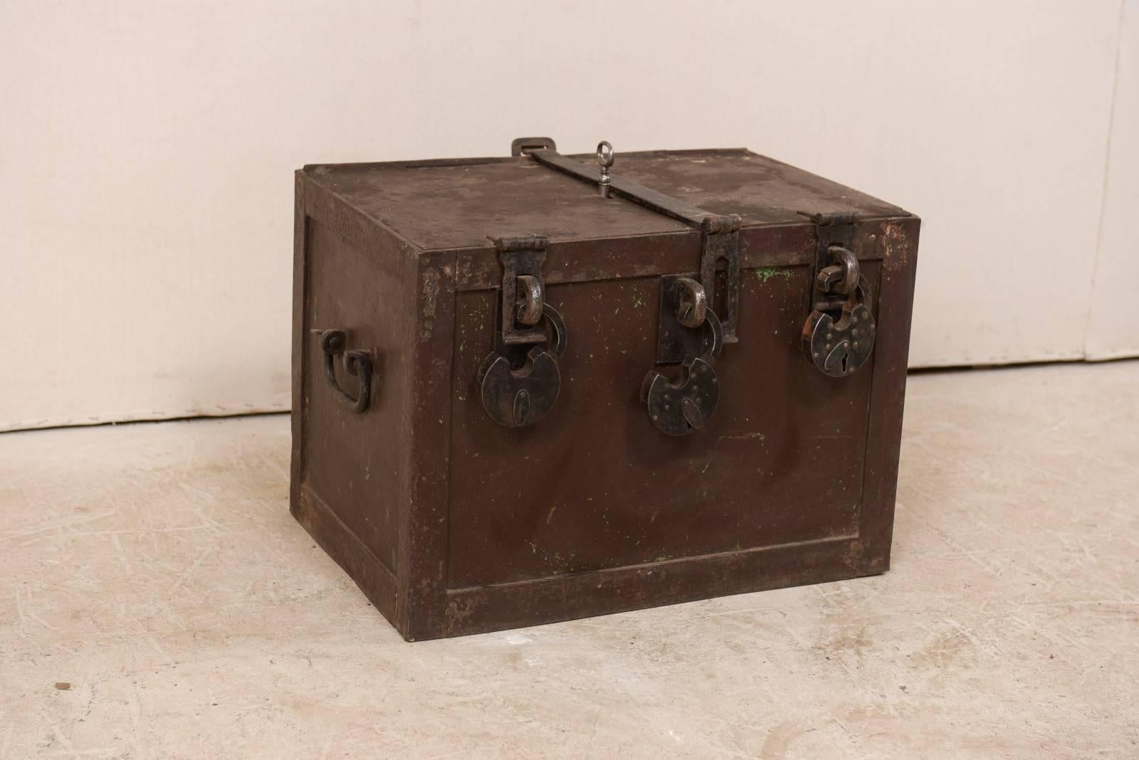 A Swedish iron safe from the 19th century. This antique Swedish rectangular-shaped iron safe features three chunky padlocks which dangle open from the front top (note that these cannot be locked at this time as they have no working key) with lid