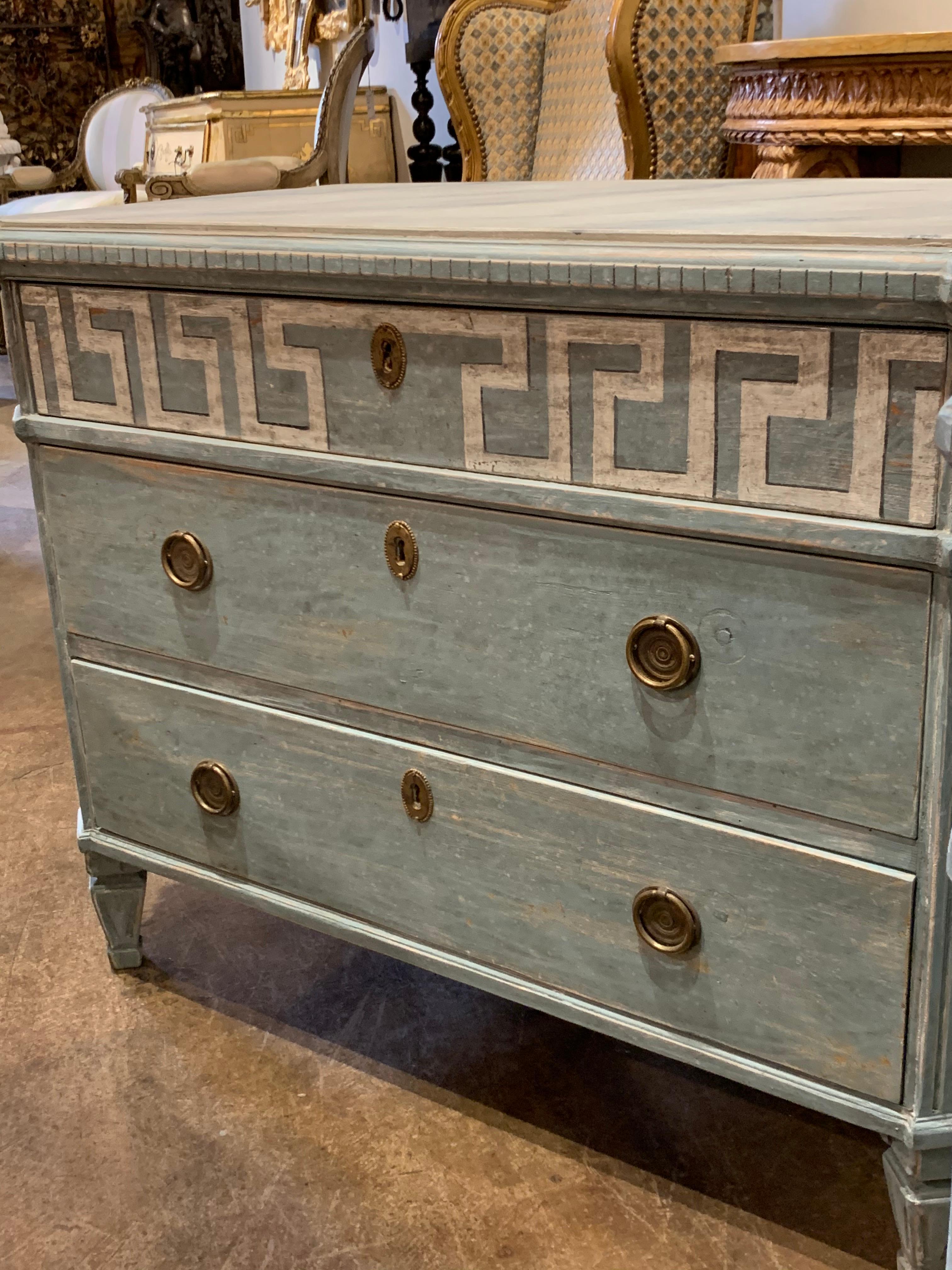 Fabulous pair of 19th century Swedish neoclassical painted chests. Painted in a beautiful blue green color with white Greek key border. And the tops are painted in creme color with grey veining pattern. Each have 3 drawers for storage. A beautiful
