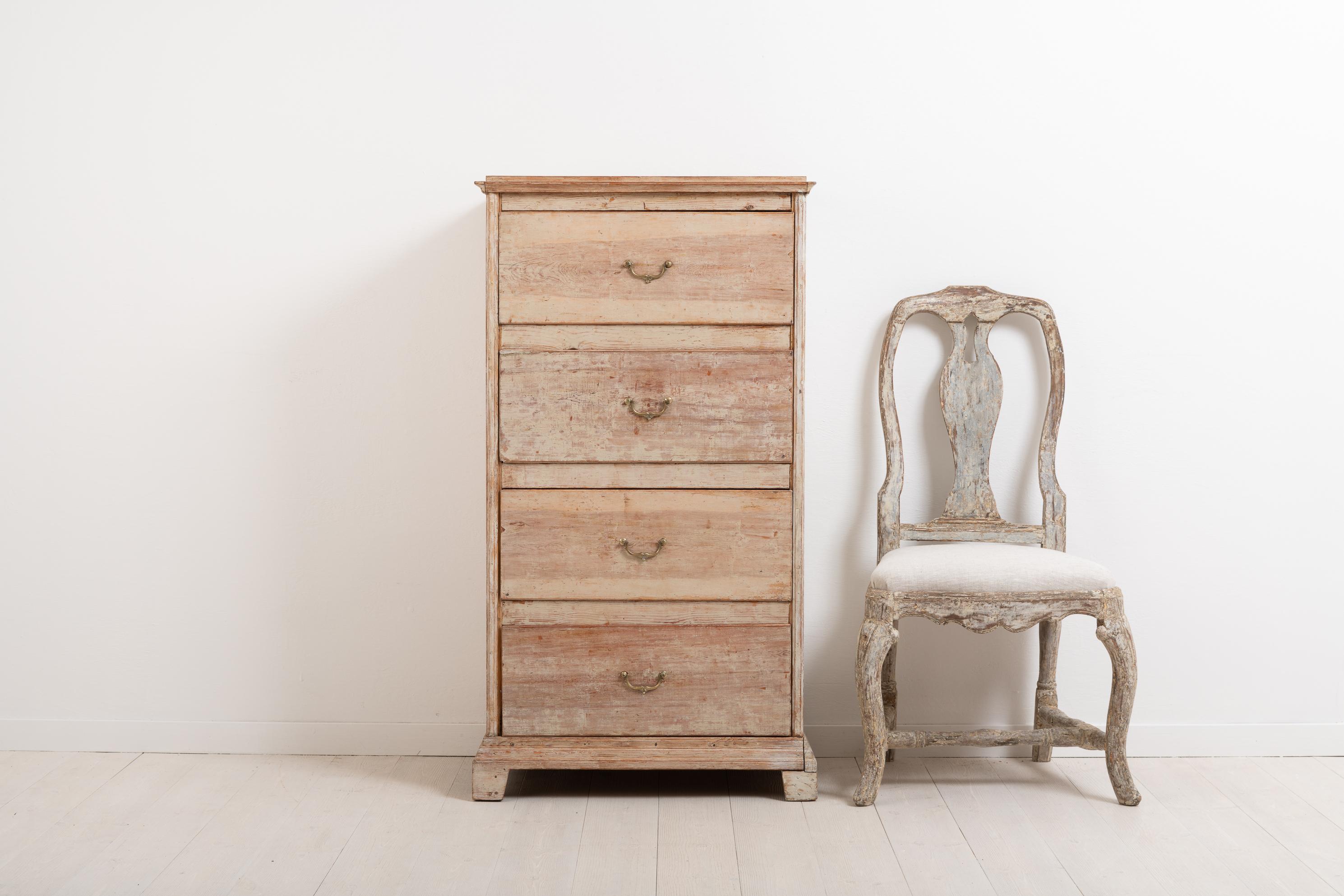 Swedish chest of drawers from the northern part of the country. The chest is made in the neoclassic style with the characteristic straight shape. Simple and minimalistic decor. It is unusually tall and narrow. Made circa 1830 in pine. The chest has