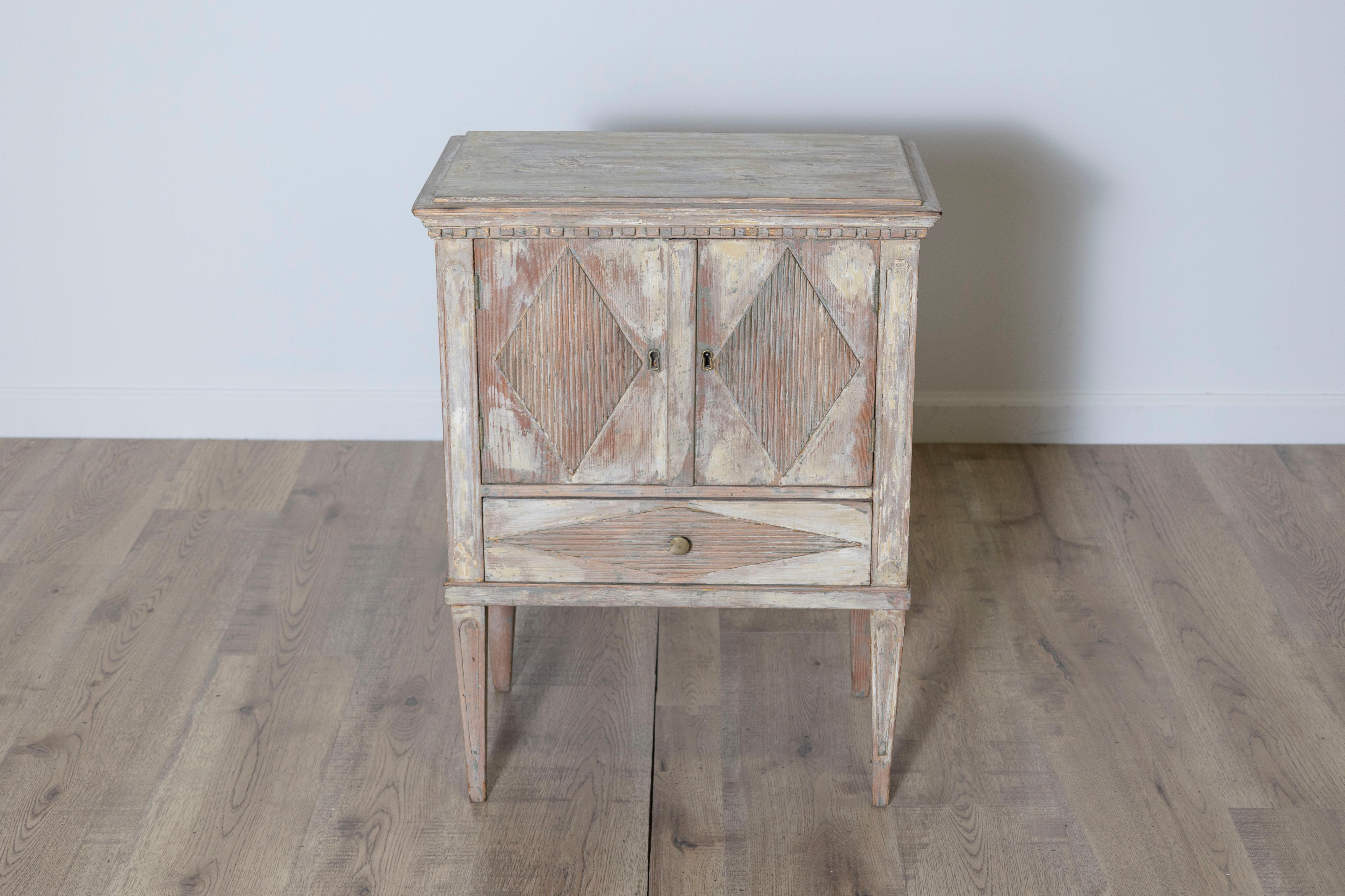This Gustavian nightstand exudes timeless elegance, embodying the refined simplicity characteristic of late 18th-century Swedish design. Carefully scraped to reveal traces of its original paint, the finish reflects a subtle patina that enhances its