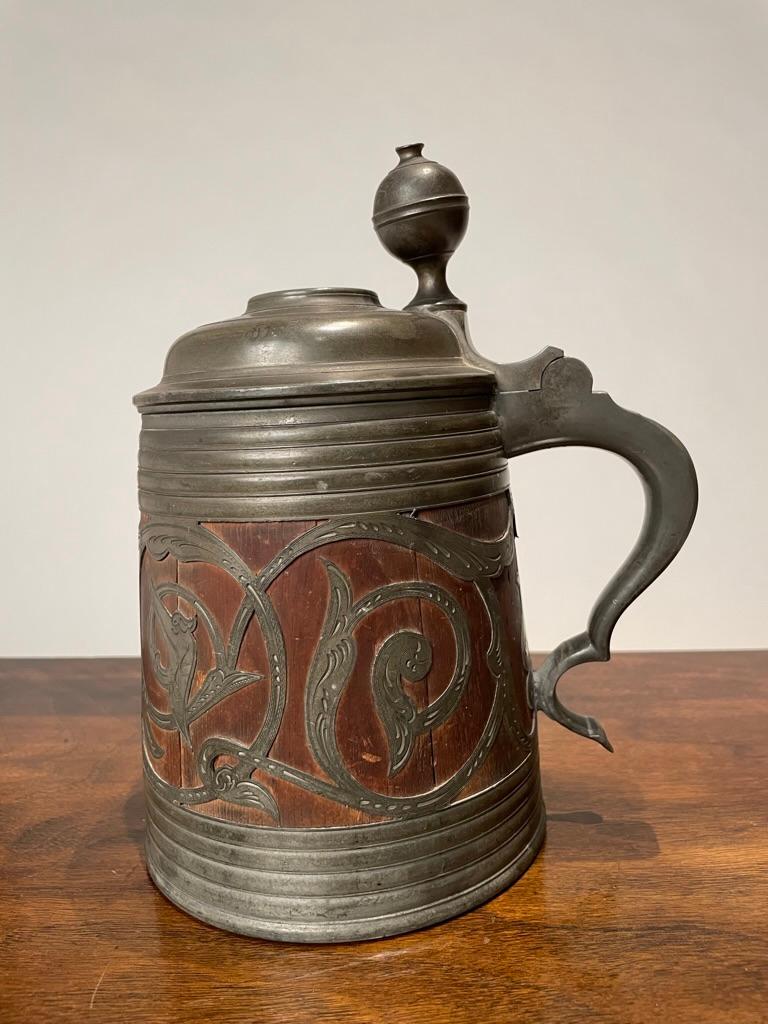 19th century Swedish oak tankard with beautiful etched pewter scroll-work decoration and royal coat of arms. The lid of the vessel is inset with a silver coin with the portrait of Carl (Charles) XV, King of Sweden and Denmark, his  coronation was in