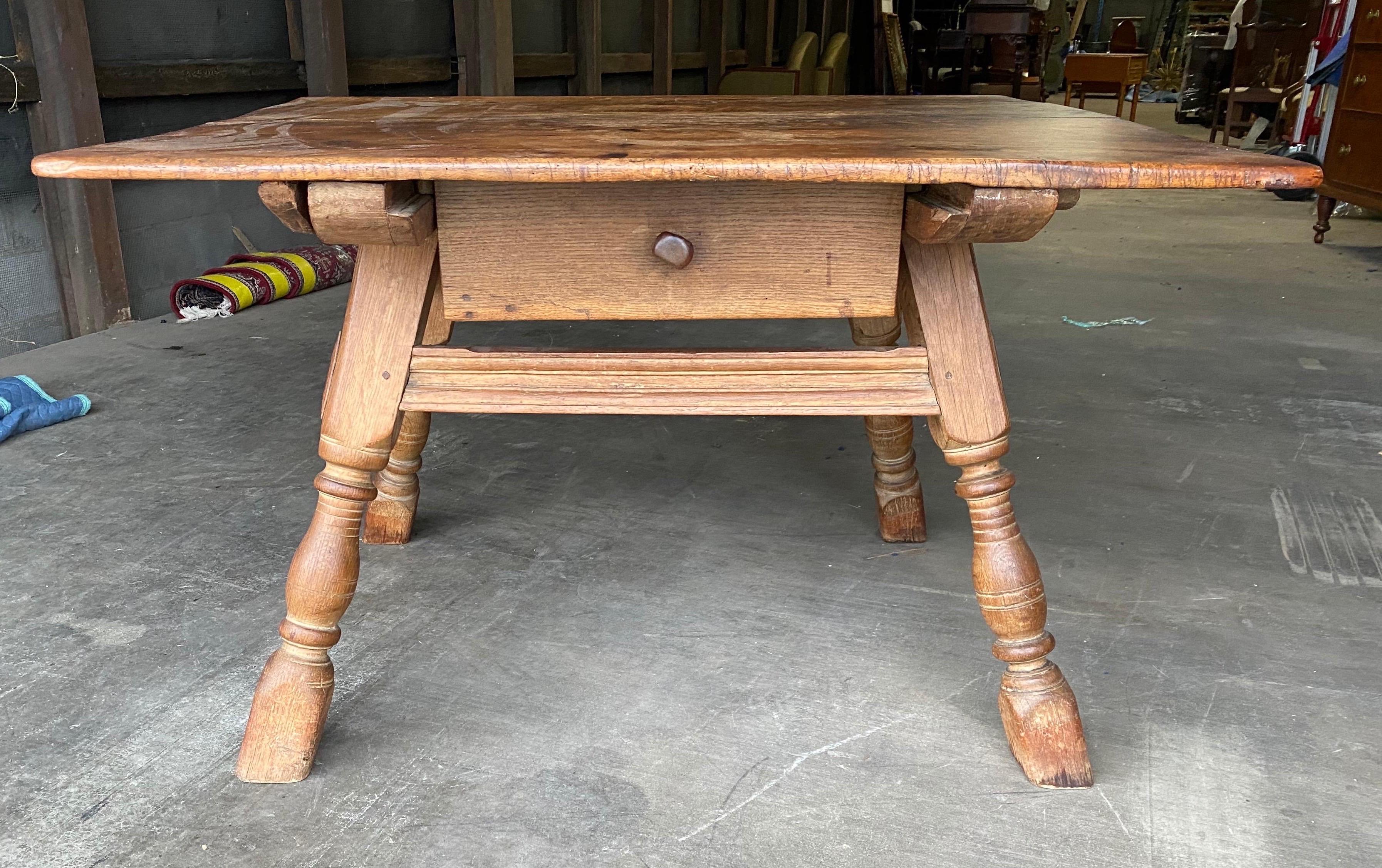 19th century Swedish oak table with drawer and scrolled apron.