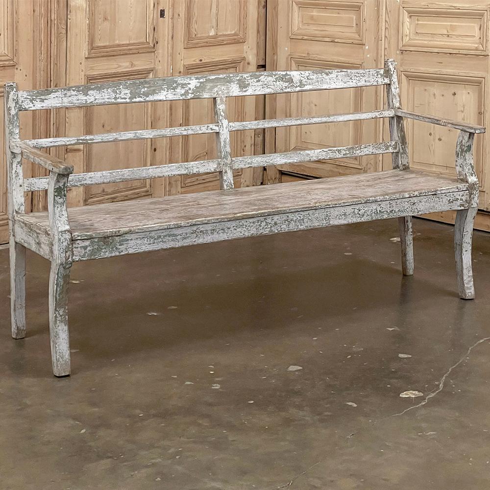 19th Century Swedish Painted Bench features a tailored, understated elegance that will lend itself well to casual decors, sun rooms, and protected outdoor spaces.  Hand-crafted from solid old-growth oak, it has been given a painted finish over the