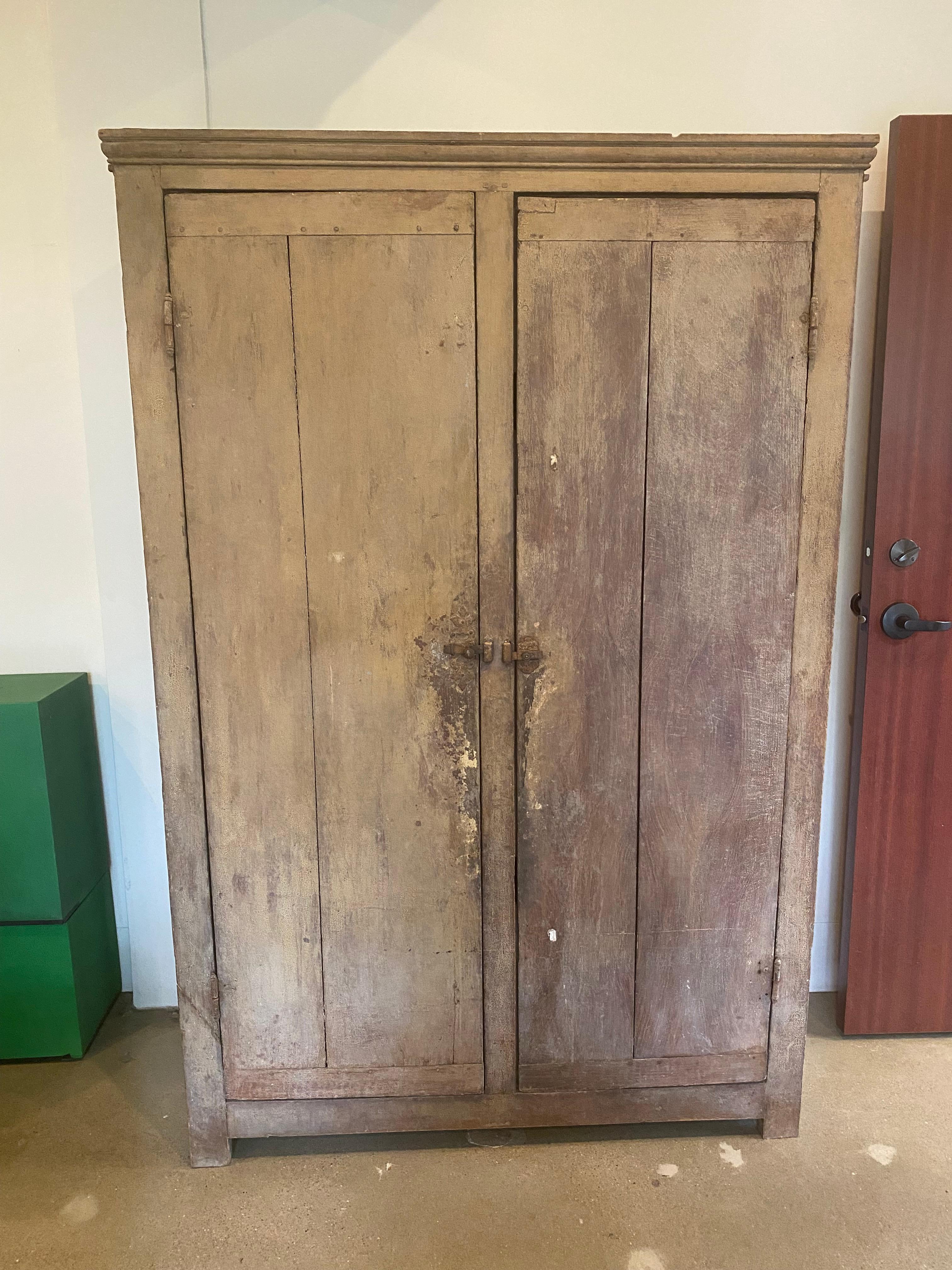19th century Swedish cabinet in original painted finish with perfect patina. Two doors open to interior shelves. A simple, industrial cabinet with less detail than some Gustavian pieces of a similar finish. Steel latches and original barrel hinges.