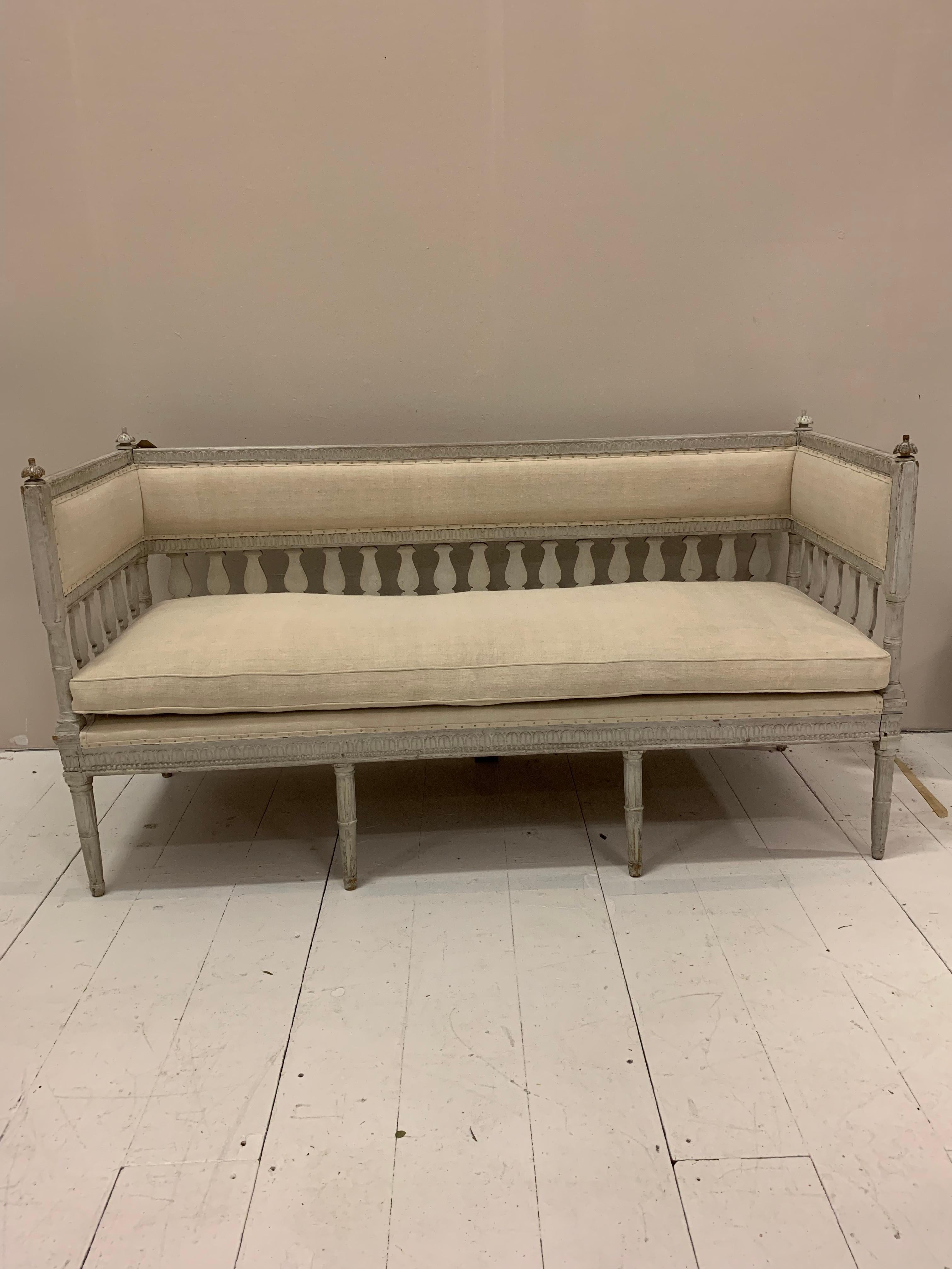 Early 19th century painted Swedish sofa.
This charming piece in Gustavian style has decorative detail to the front and sides.
Open stylish stick back with decorative finals to the top.
(Back two replaced)
It has been repainted over time to a
