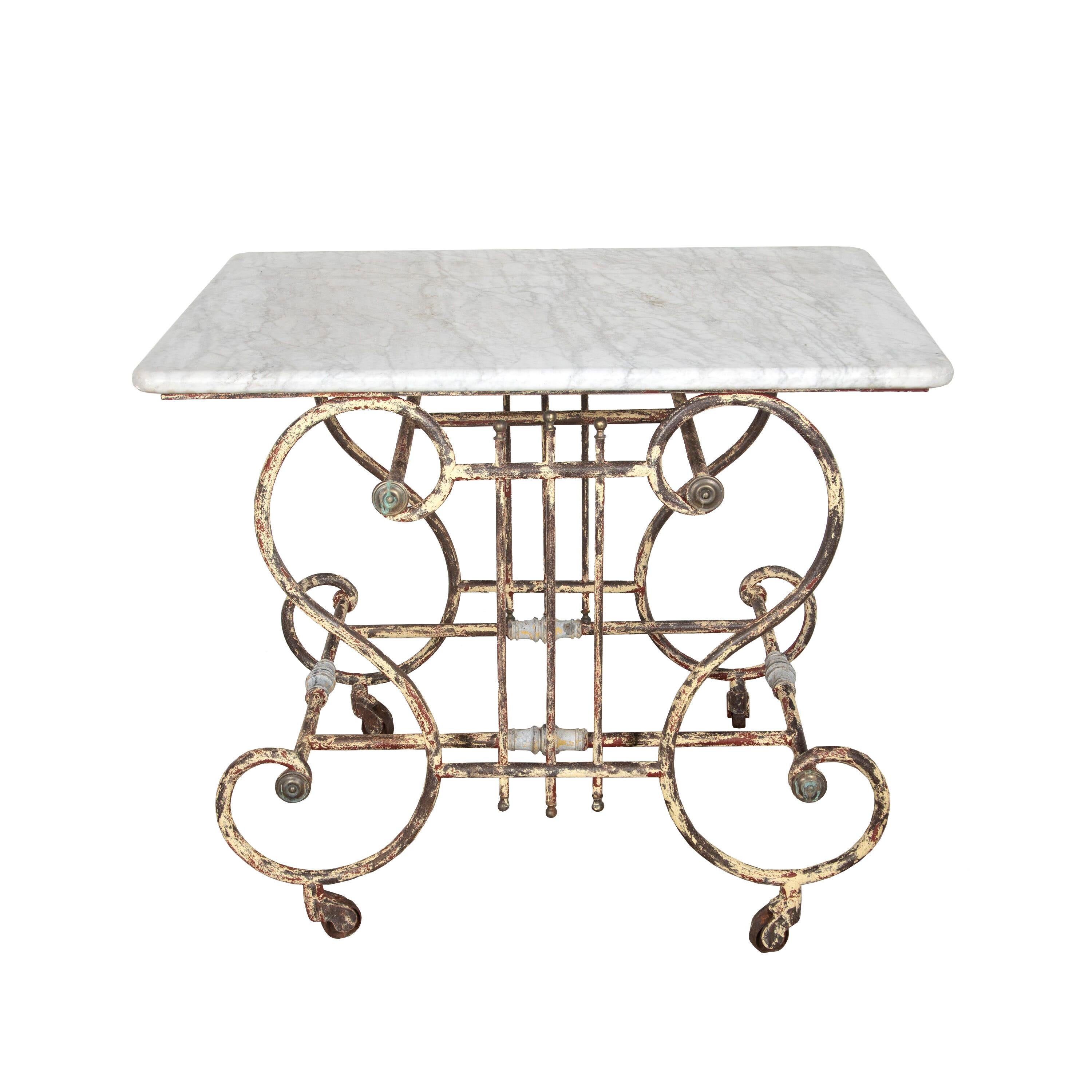 19th century French iron patisserie table with a decorative base in the shape of a lyre. This piece features a time worn patina, an original marble top.
