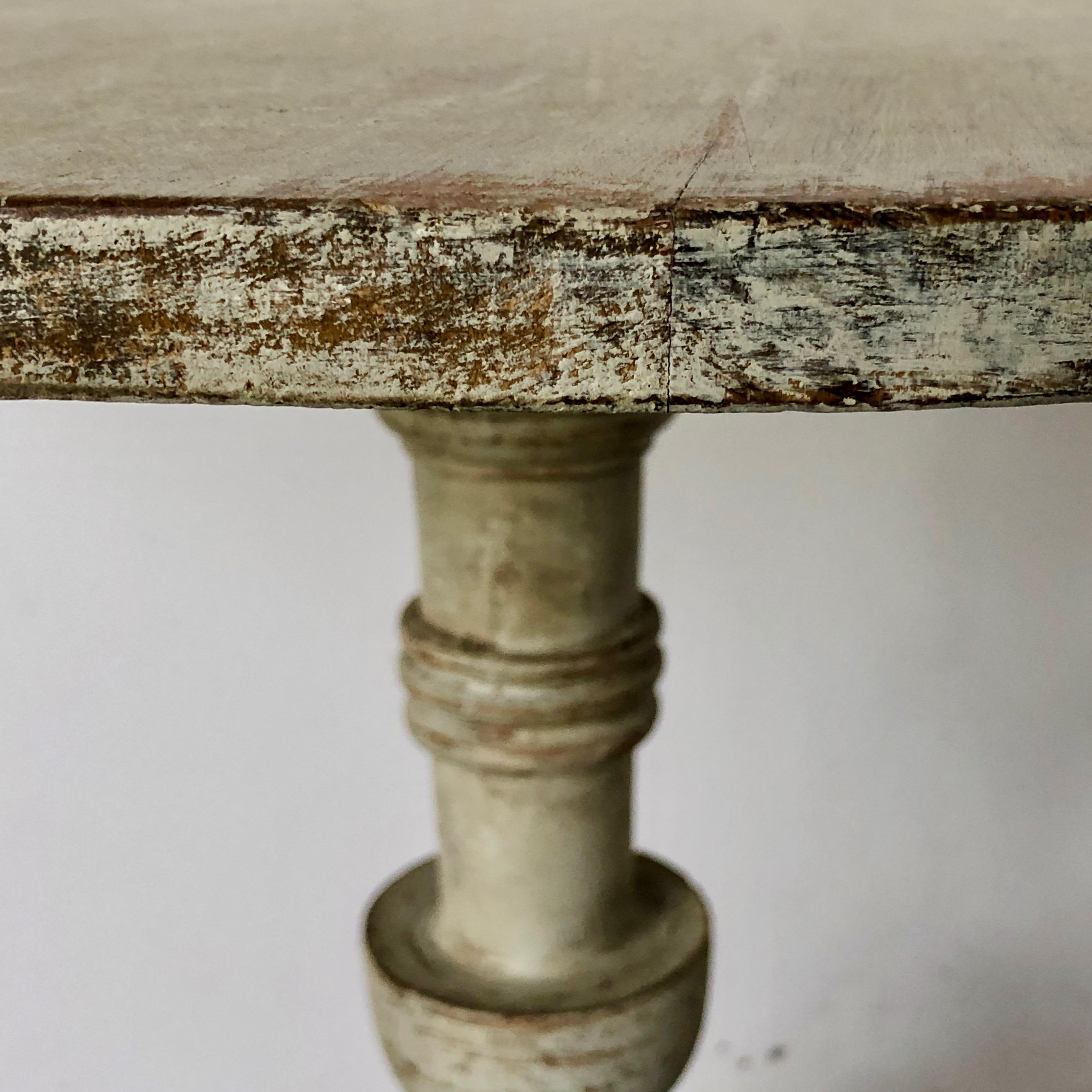 Early Swedish 19th century painted pedestal table with turned base supported by beautifully carved legs. Scraped pack to traces of its original paint.
Värmland, Sweden, circa 1830.
 