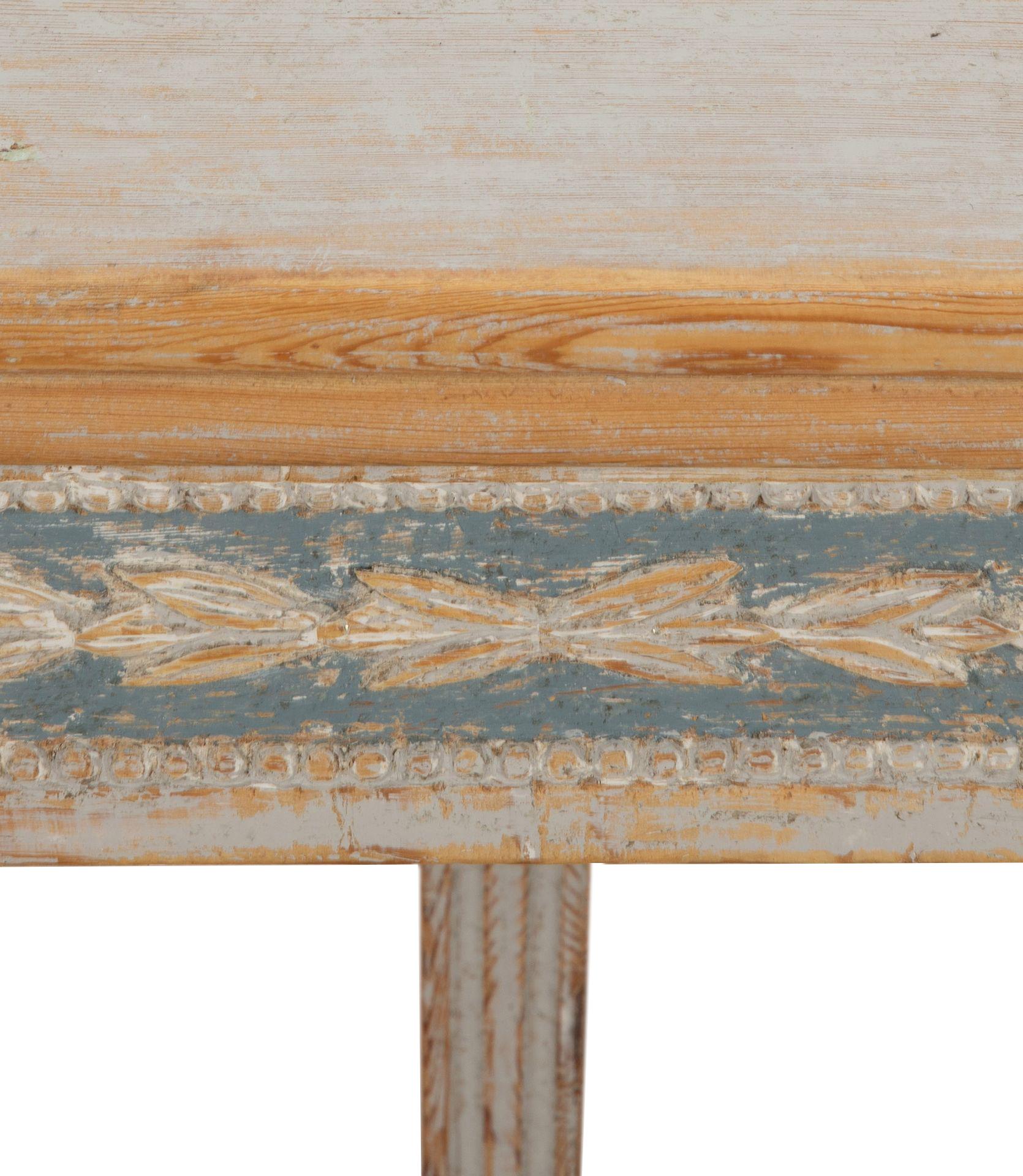 Early 19th Century Swedish, period Gustavian folding card table.
Featuring one folding leaf with decorative carved acanthus leafs on three sides, reeded legs and storage drawer. 
Repainted in soft grey and blue paint. 
Circa 1800.