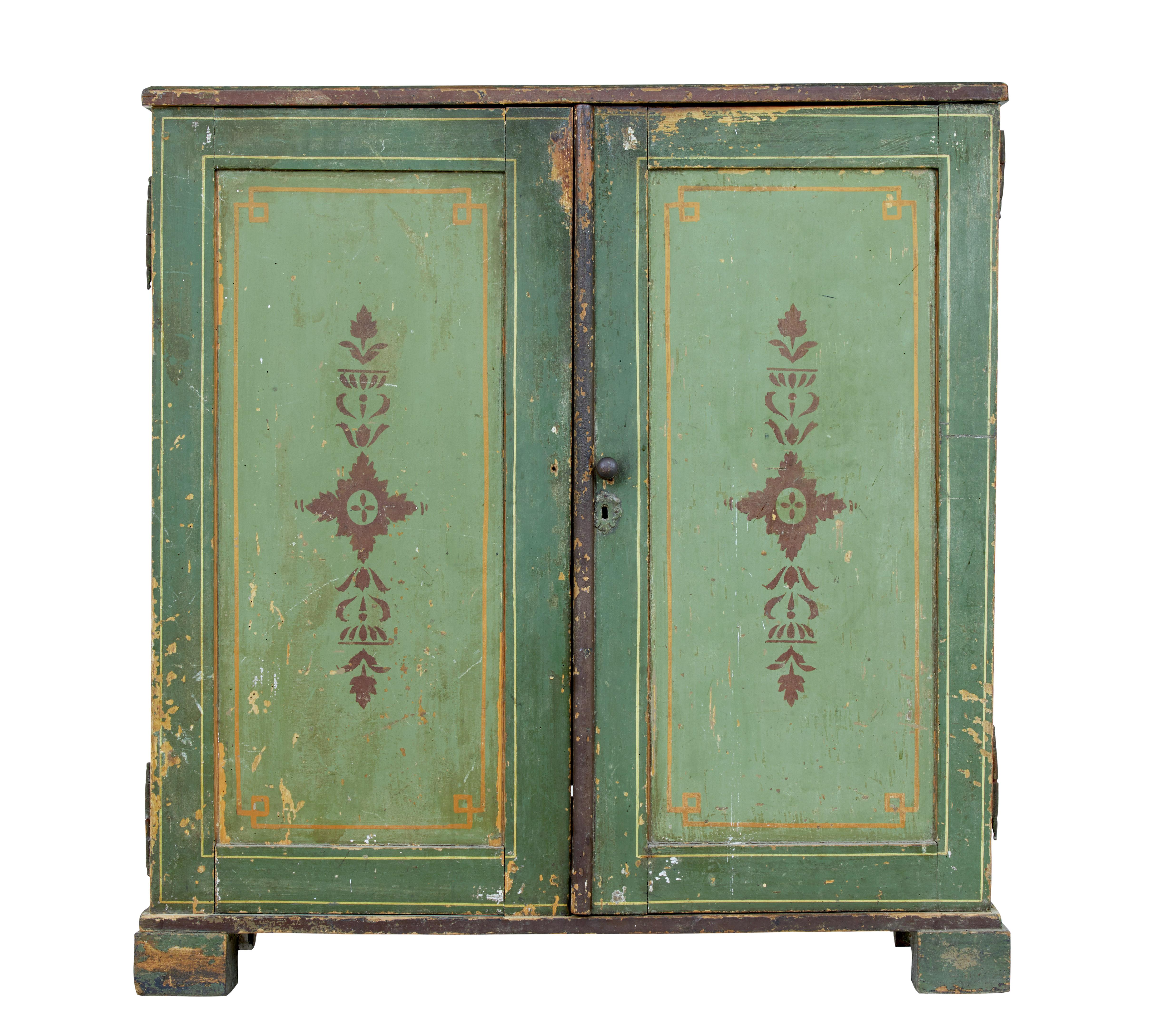 Beautiful decorative Scandinavian cabinet circa 1850.

Green 2-tone original paint with gold string design and stenciled motif to the door fronts. Double doors open to reveal 2 fitted drawers below the top surface and 2 fixed shelves.

Standing