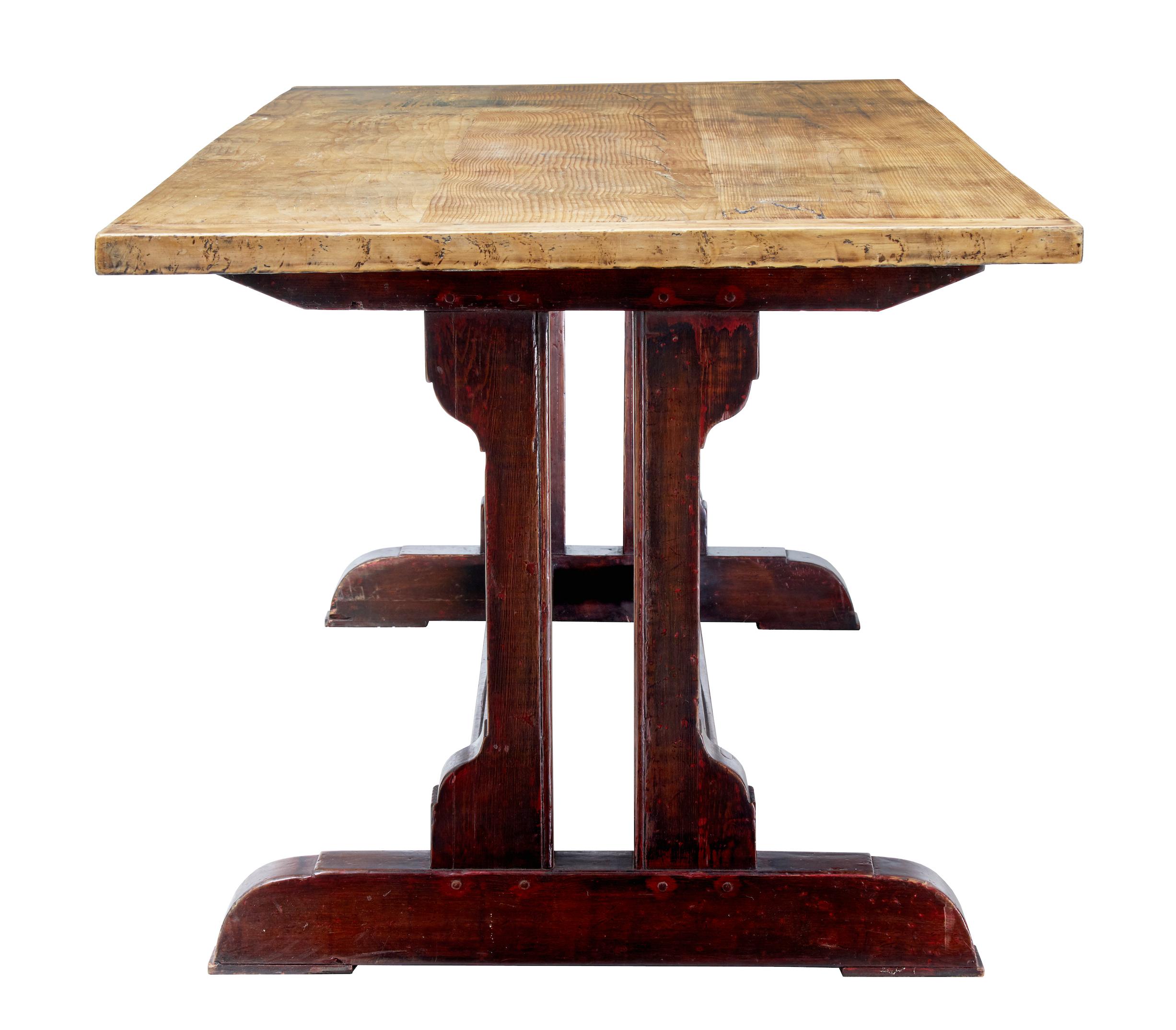 Beautiful rustic Swedish dining table, circa 1860.

Trestle end base united by two central stretchers with original paint. Original pine top with cleated ends and dowels.

Seats a comfortable eight.

Obvious signs of use on the top surface and