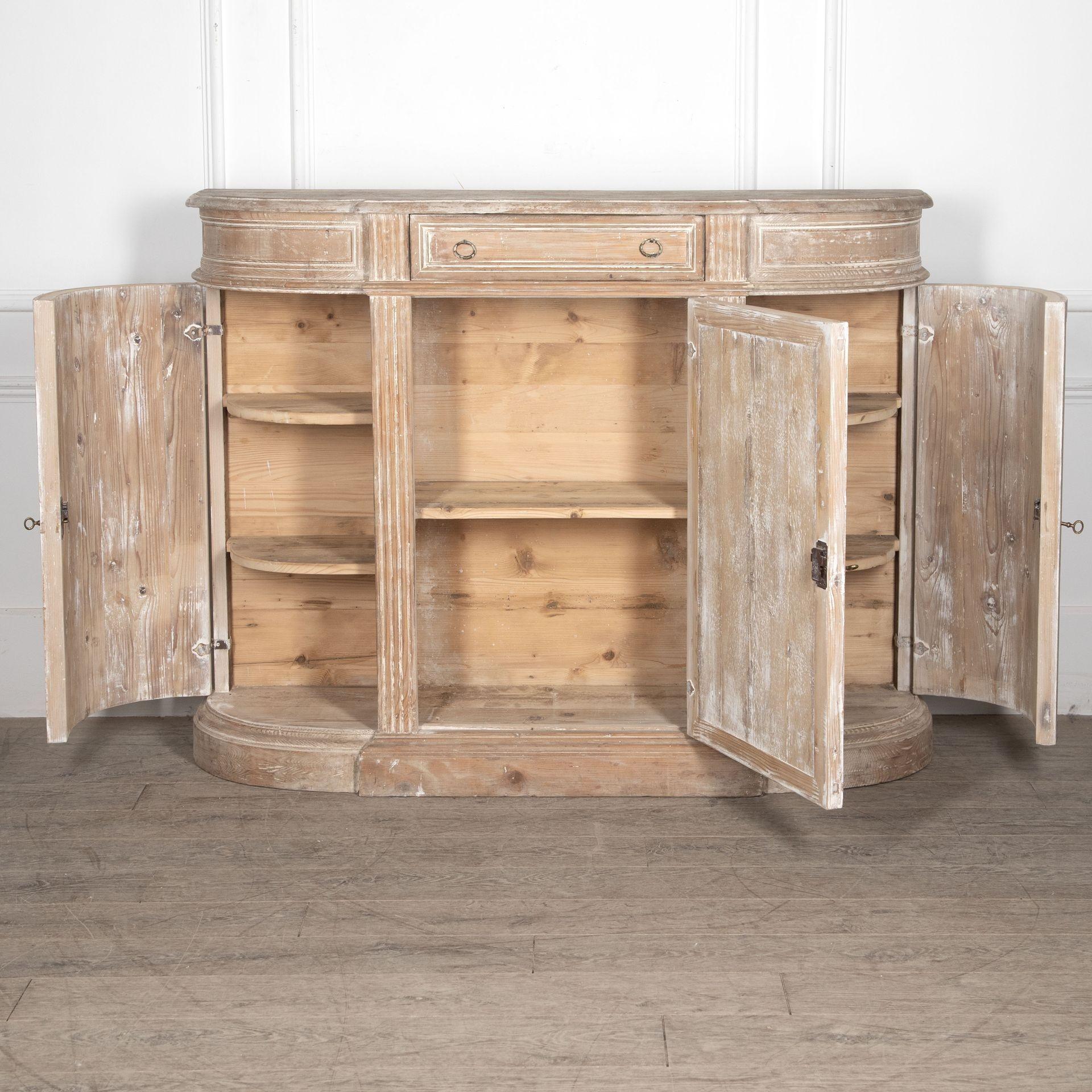 19th Century Swedish pine sideboard.

The central cupboard door with a drawer above, enclosing a shelf and flanked by bow ends either side.

The bow sides with a cupboard door to each enclosing a shelf, the whole supported on a stepped moulded