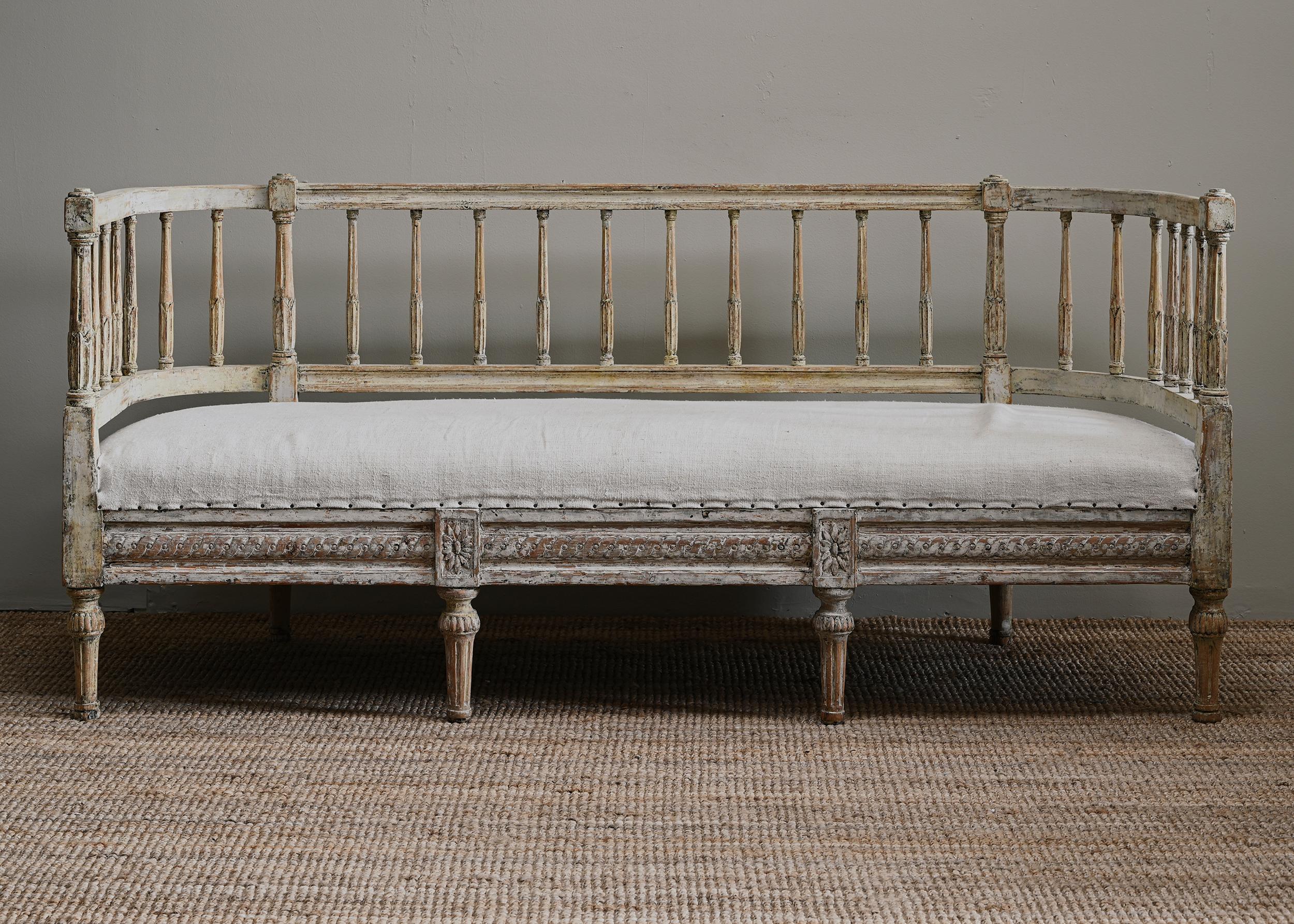 Fine 19th century provincial Gustavian sofa with an unusual curved back rest in its original finish with retouches. Ca 1810, Sweden. Newly upholstered in linen.