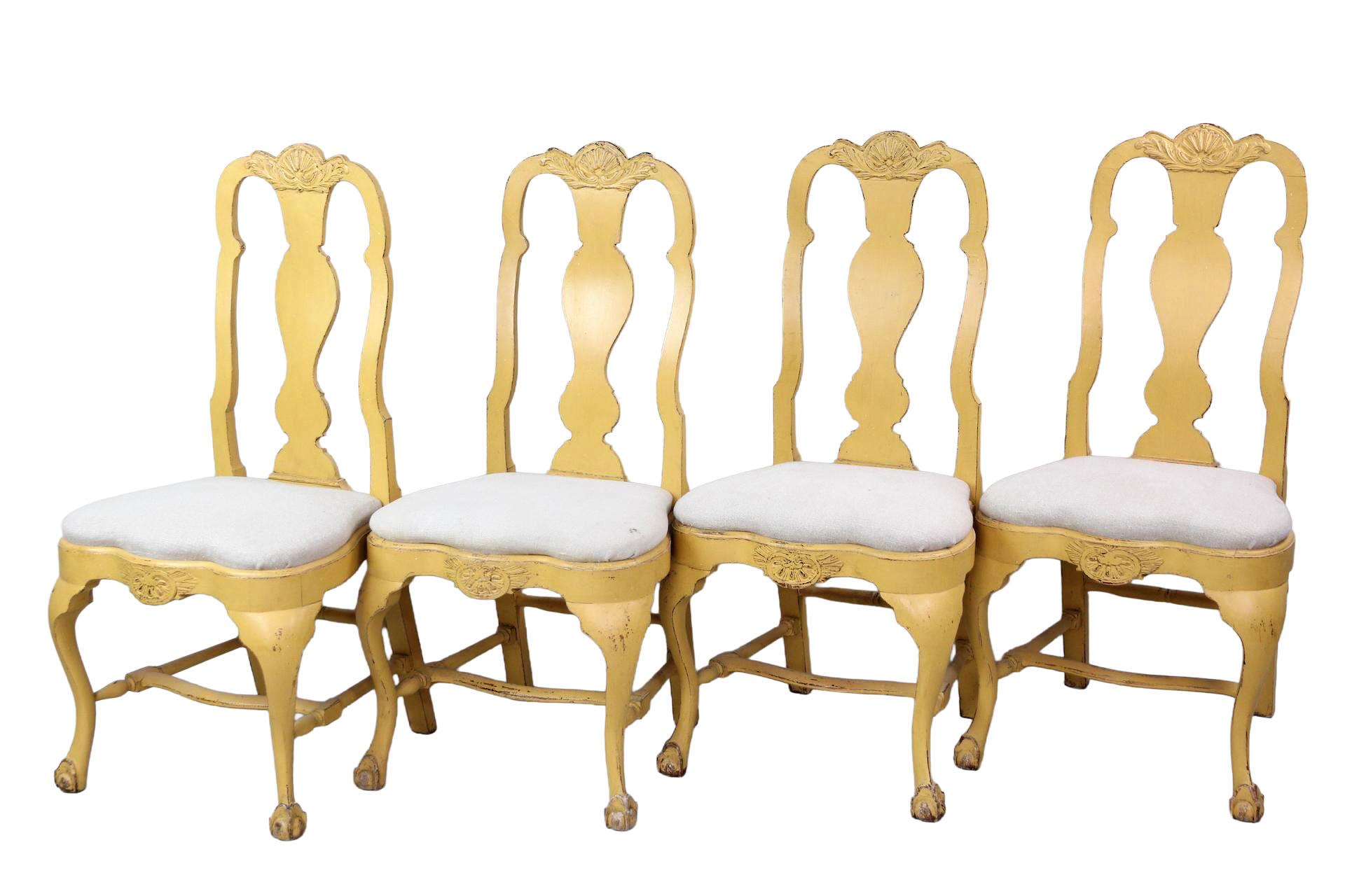 A set of ten 19th-century Swedish rococo-style dining chairs, freshly painted in ochre, exudes graceful period character and a warm, meticulously restored finish. The gently curved crest rail showcases a delicate carved floral-and-leaf motif above a