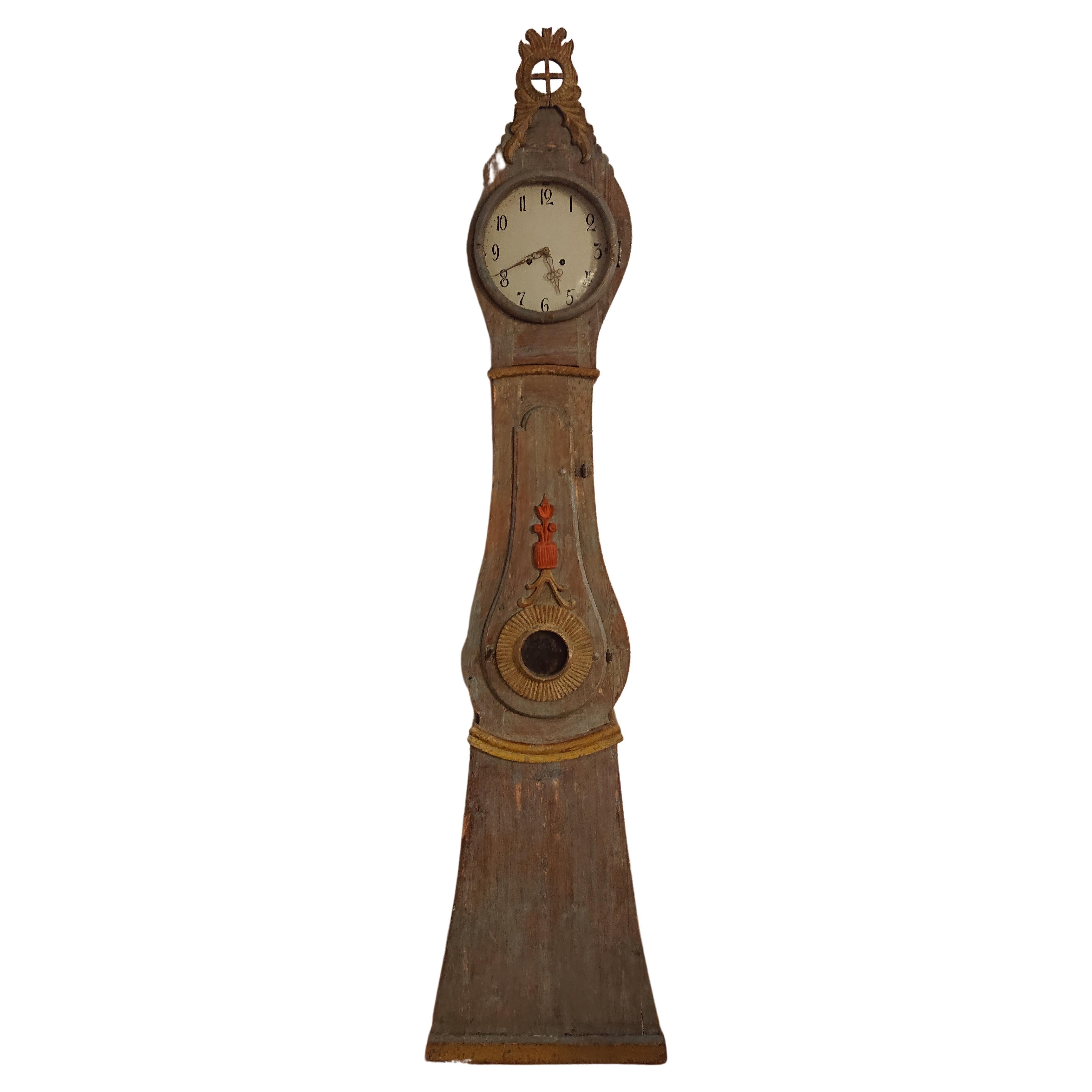 19th century Rococo tall case clock from Boden Norrbotten, Northern Sweden. Made in wood. Nice details and carvings in shape of flowers and leaves. The Middle of the case has a windowed door to access the inside. This Piece has been hand scraped