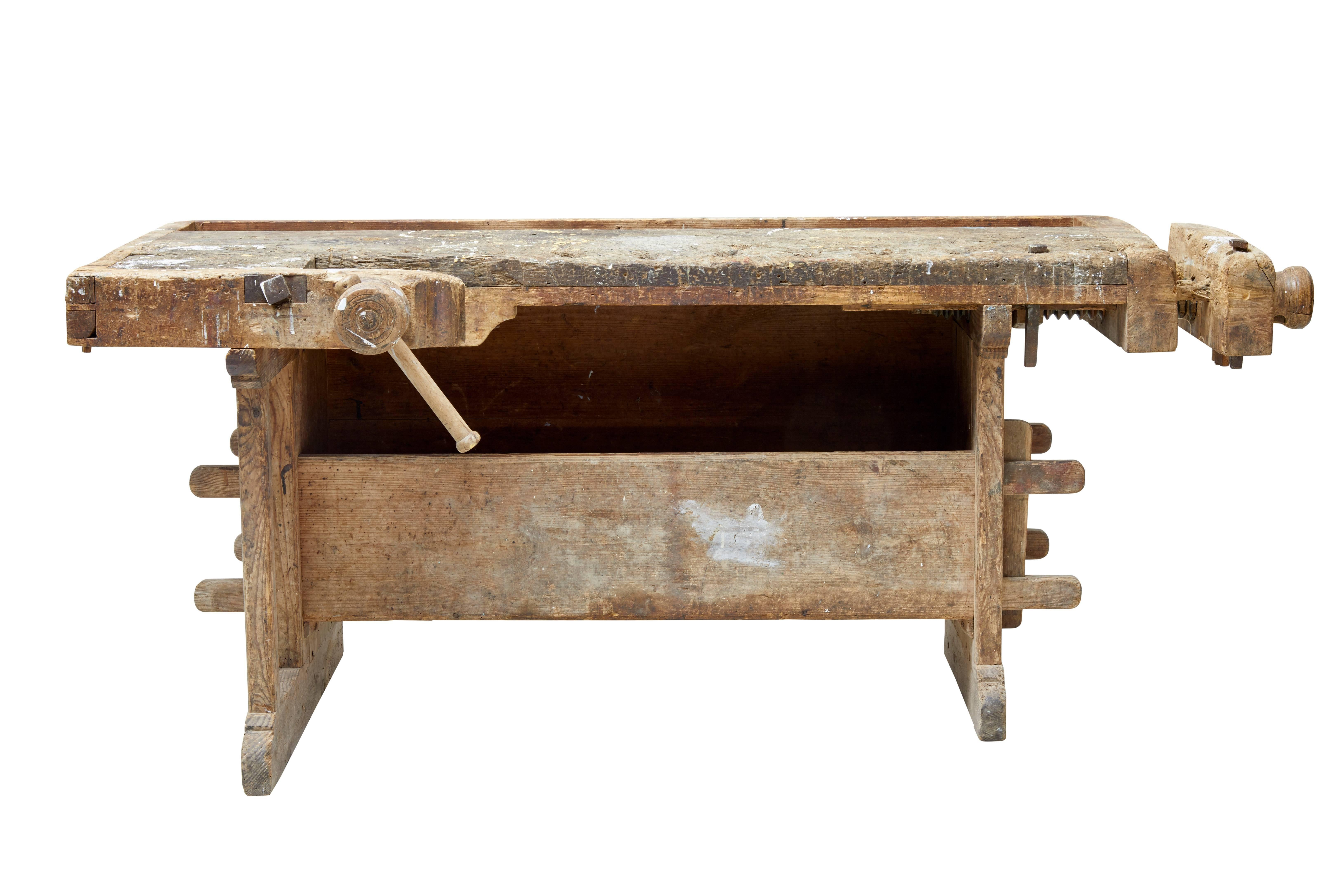 Traditional Swedish pine work bench, circa 1870.

This work bench has obviously produced plenty of wood work in its life time but is capable of producing more or being used as a display.

Oak top with double clamp on one end and spindle clamp to