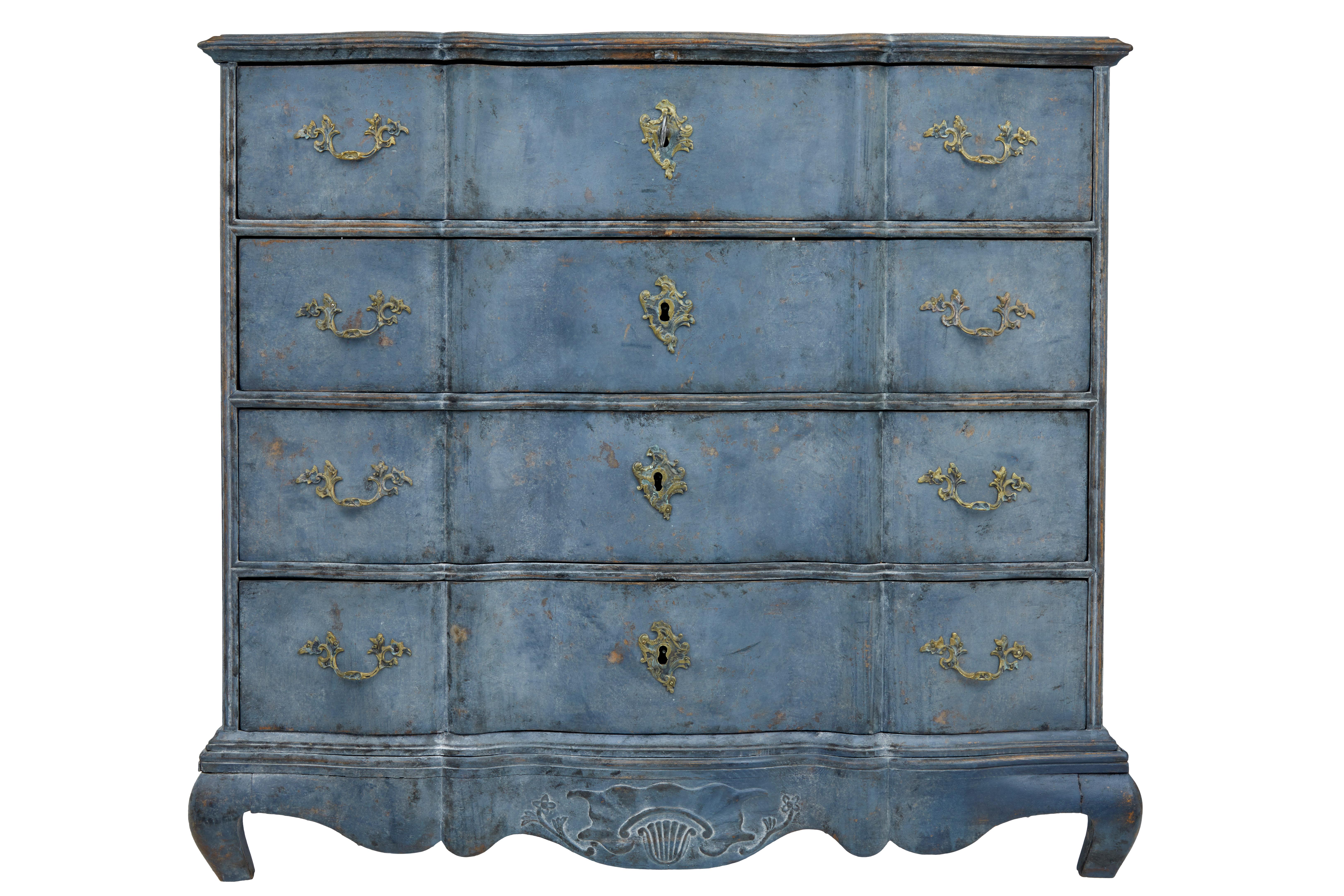 Beautiful mid-19th century chest of drawers, circa 1860.
Four-door oak chest, with shaped front and ornate brass hardware.
Iron carrying handles to the sides.
Carved shell patterned frieze.
Later paint, which is now faded with losses.
Heavy