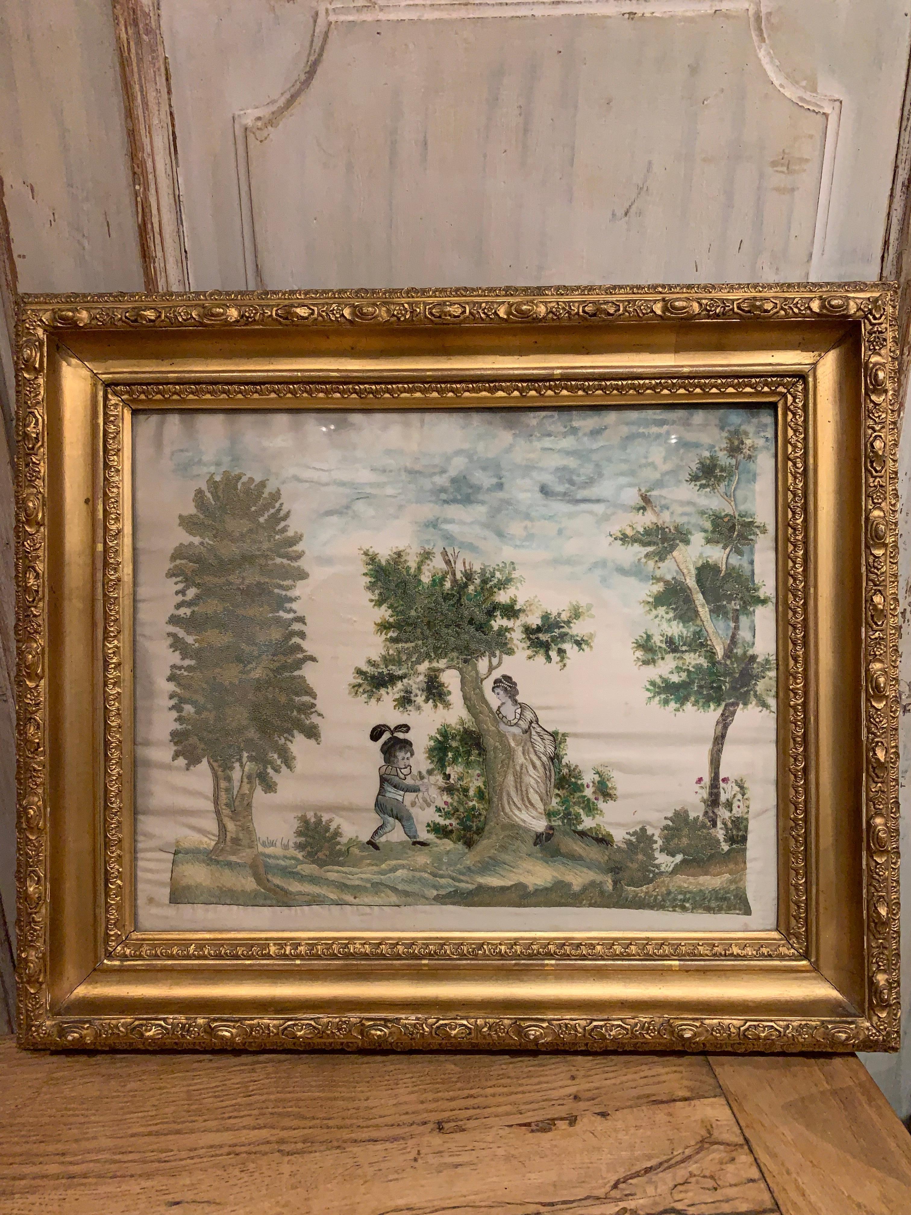 Charming early 19th century Scandinavian silk work of a child and mother in a woodland scene playing and berry picking.
Later framed in a gold frame. The silk work is in good condition and depicts a young boy in a pale blue suit wearing a hat with
