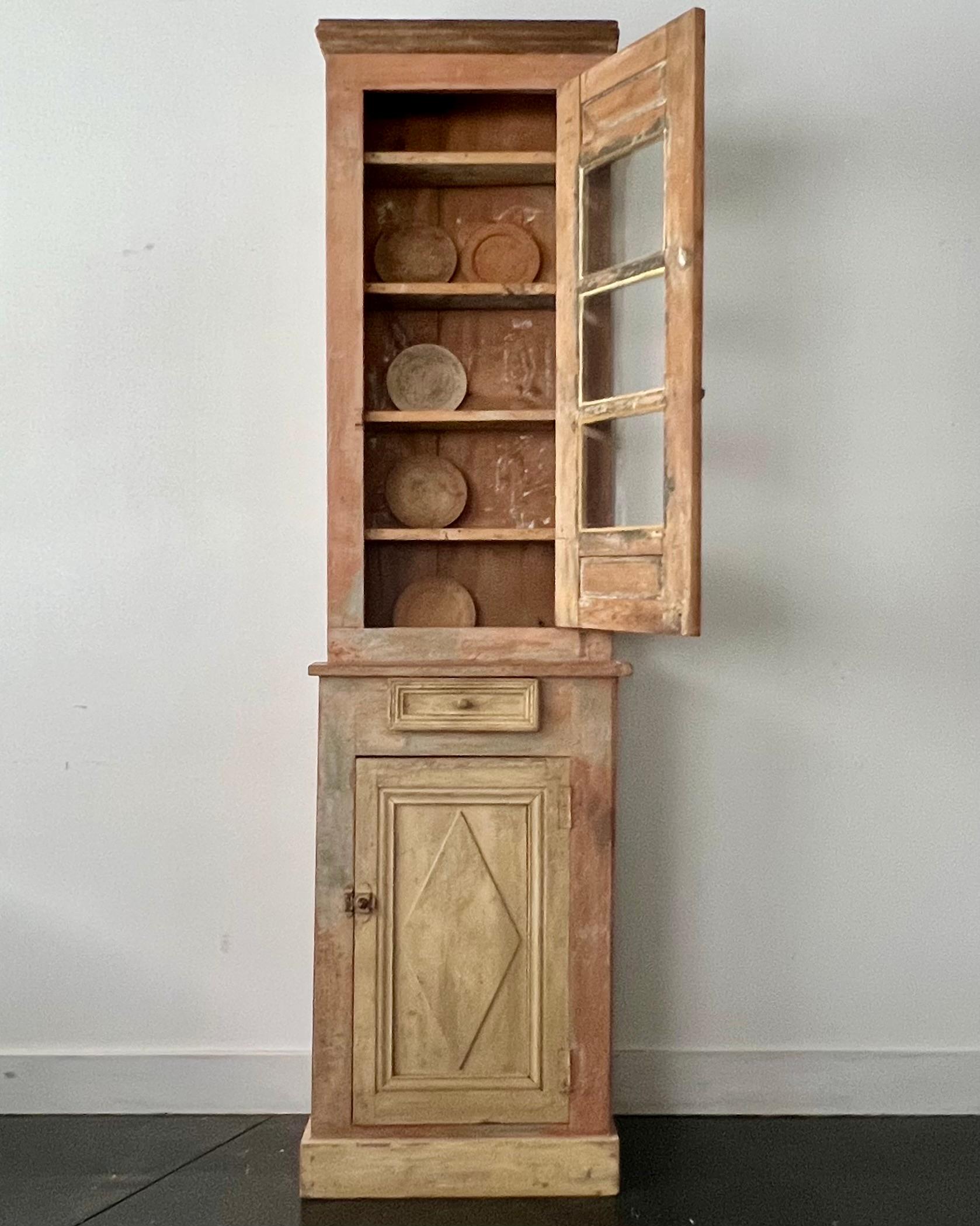 19th century Swedish rustic tall and narrow Vitrine Cabinet, Upper part cabinet with glass paneled doors and the classic diamond  shape motif.
Lower part cabinet wit on drawer and one door base.

