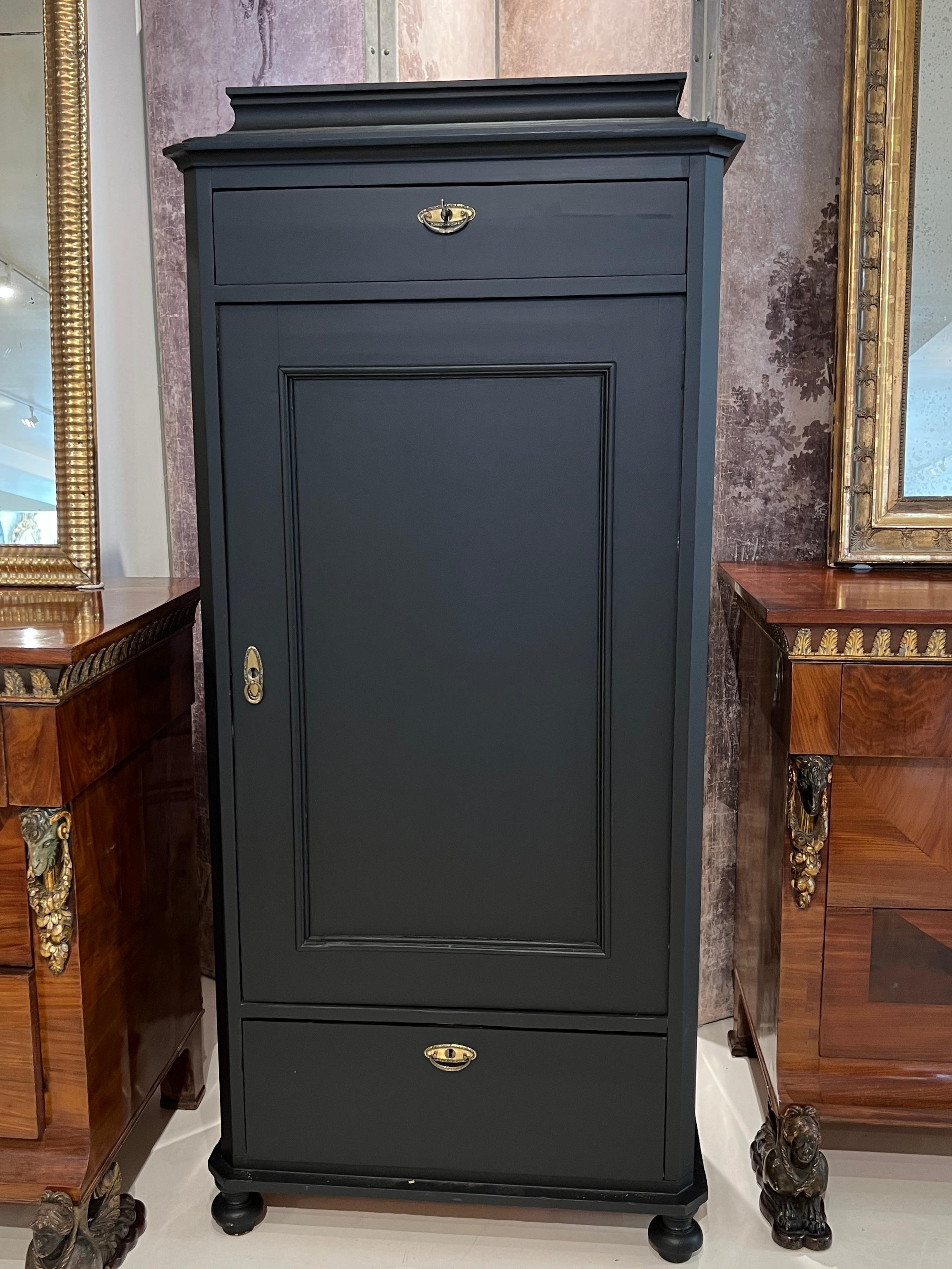 This 19th century Swedish tall cabinet is finished in a rich, matte black with clean Gustavian lines and simple paneling, offering a dramatic yet timeless storage piece that blends effortlessly into both classic and modern interiors.