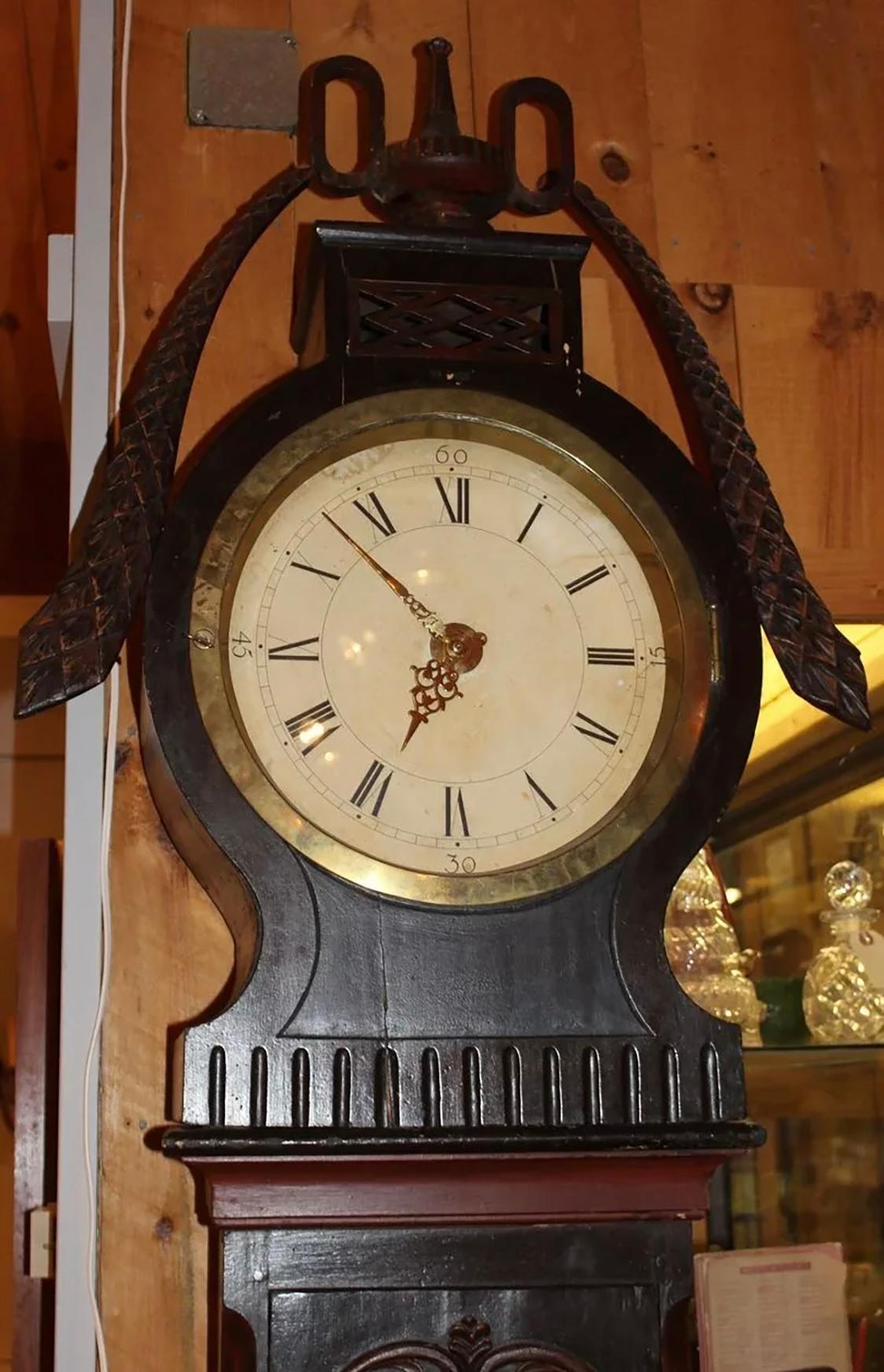 Wonderful polychrome 19th century Swedish tall case clock with central urn with swags, Roman numeral dial, brass works and waist door with circular window. Very good overall condition, with minor staining on clock face, other imperfections,