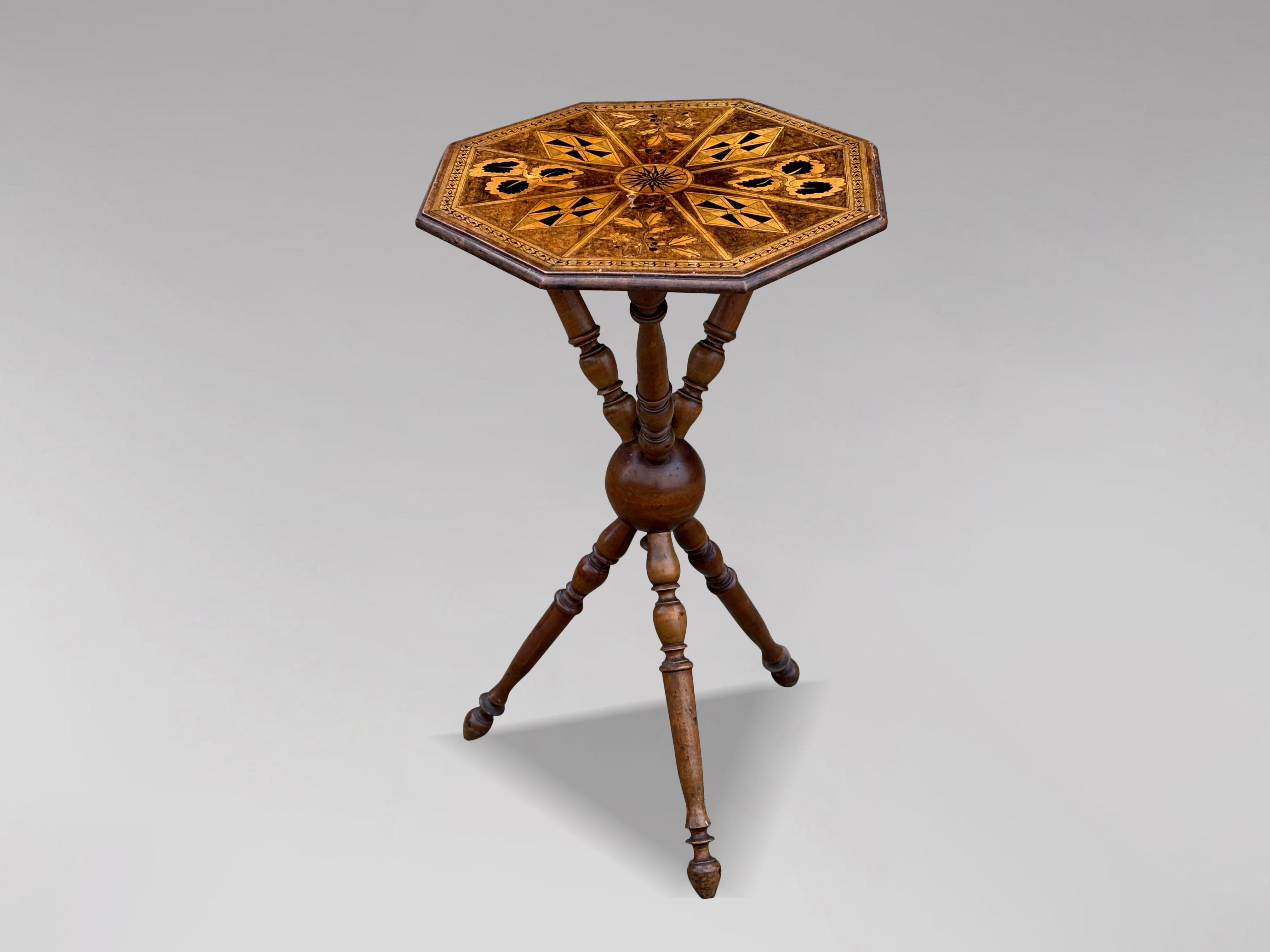 This distinctive late 19th-century walnut side table showcases an elegant octagonal marquetry and inlaid top, crafted with intricate detailing that reflects the era’s superior craftsmanship. The table rests on a beautifully designed tripod base with