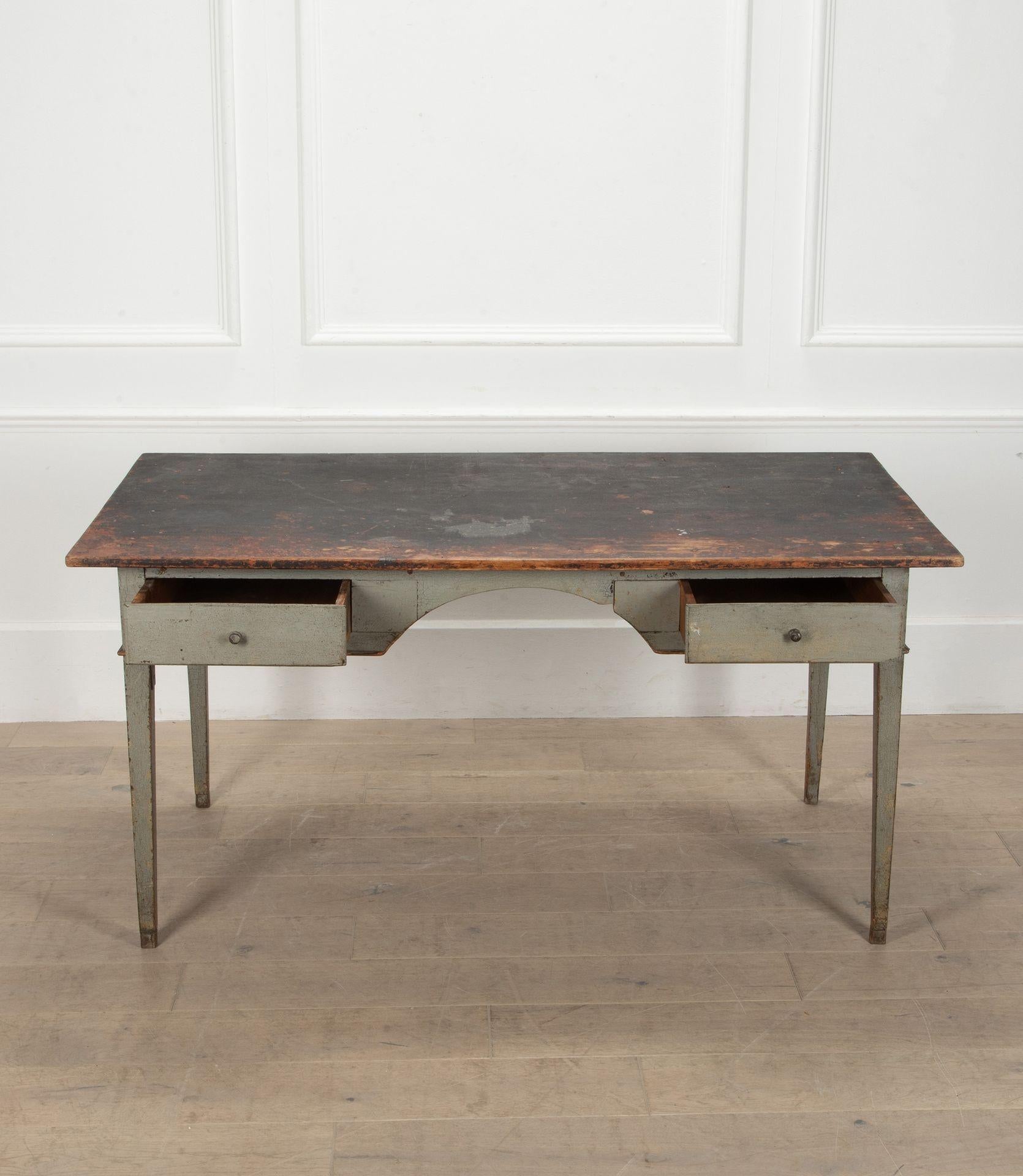 A good scale 19th Century Swedish writing table in old paint. The top has been replaced, many years ago, and the legs have had rather rustic tipping to raise the writing surface! A charming and very useful piece.