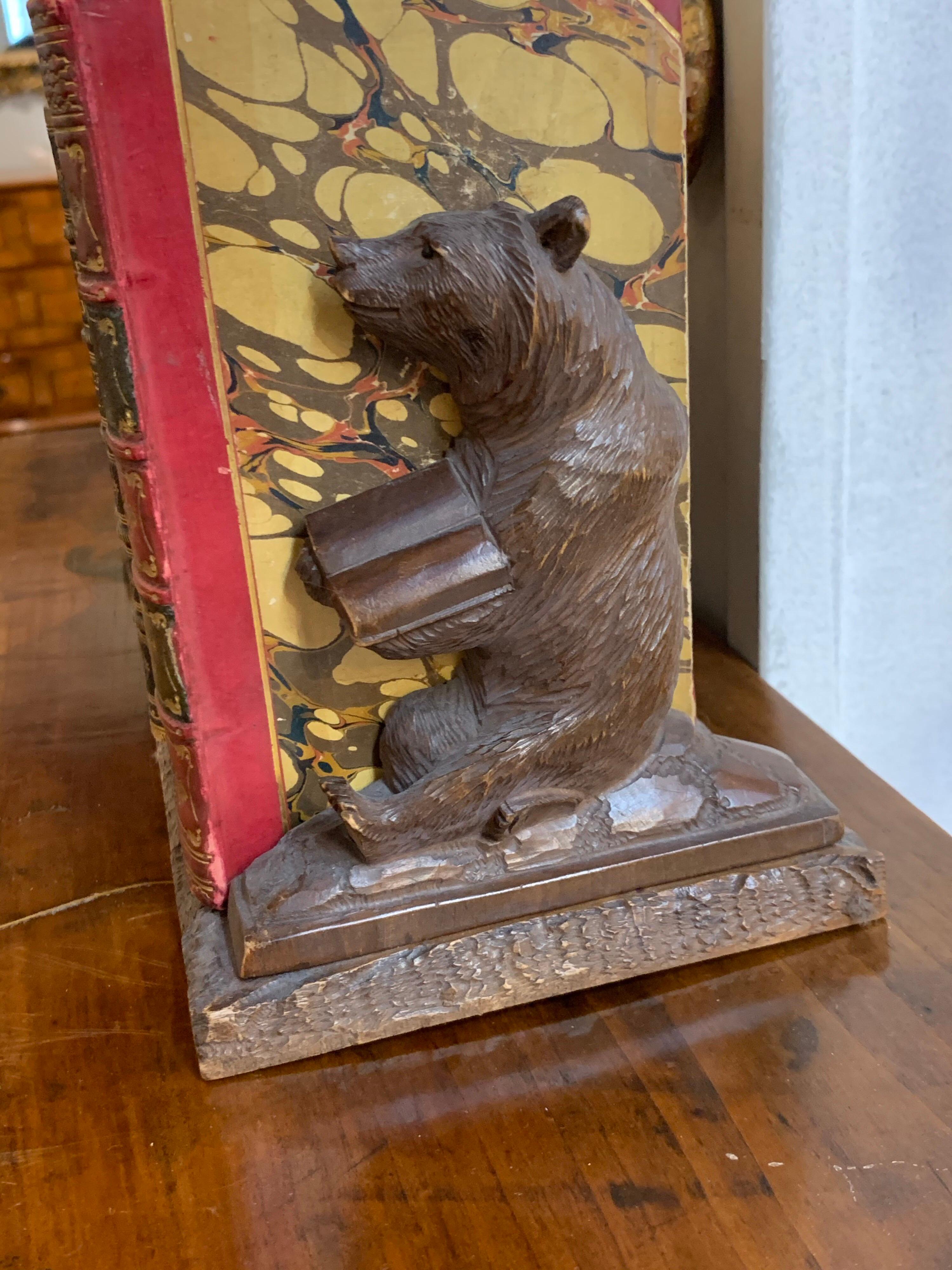 Nice Black Forest bear shaped book ends. This set also comes with a very fine set of 11 antique leather bound books. Would make an interesting gift!