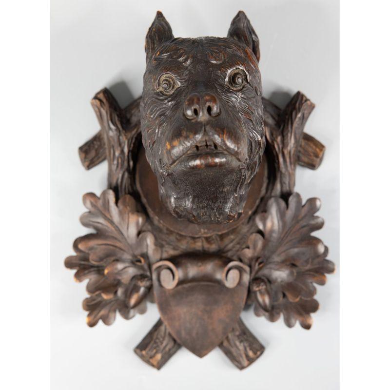 A fine antique 19th-Century black forest Swiss hand carved dog head sculpture plaque. It's perfect for your rustic lodge decor or in a study and would be a wonderful gift for the dog lover or collector.

 