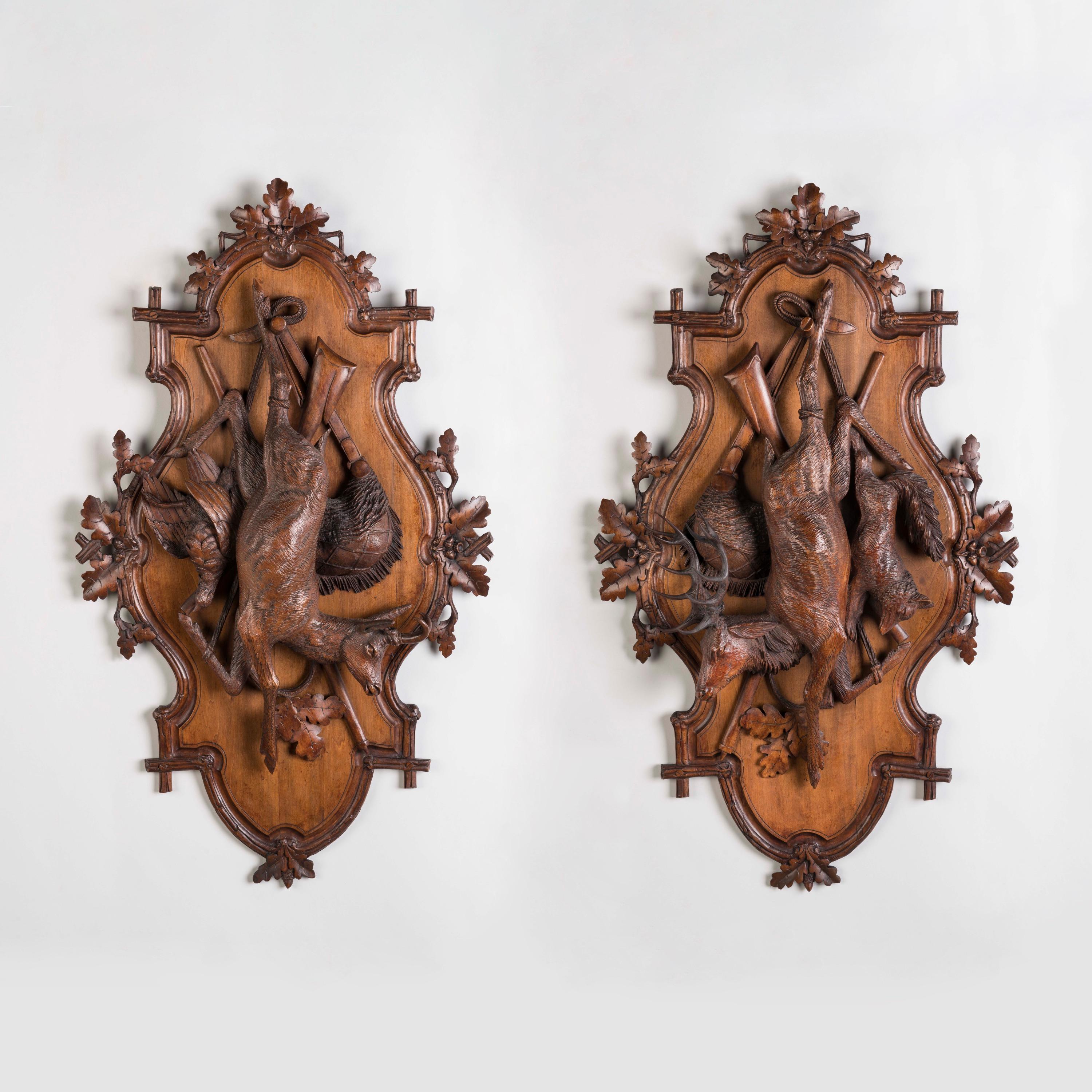 A Pair of Carved Black Forest Game Plaques

Expertly carved in Lindenwood, the shaped plaques, carved with oak leaves, depicting a chamois, deer, bird, fox and hunting accoutrements, hung as trophies.
Brienz area, Switzerland, Circa 1890

Brienz,