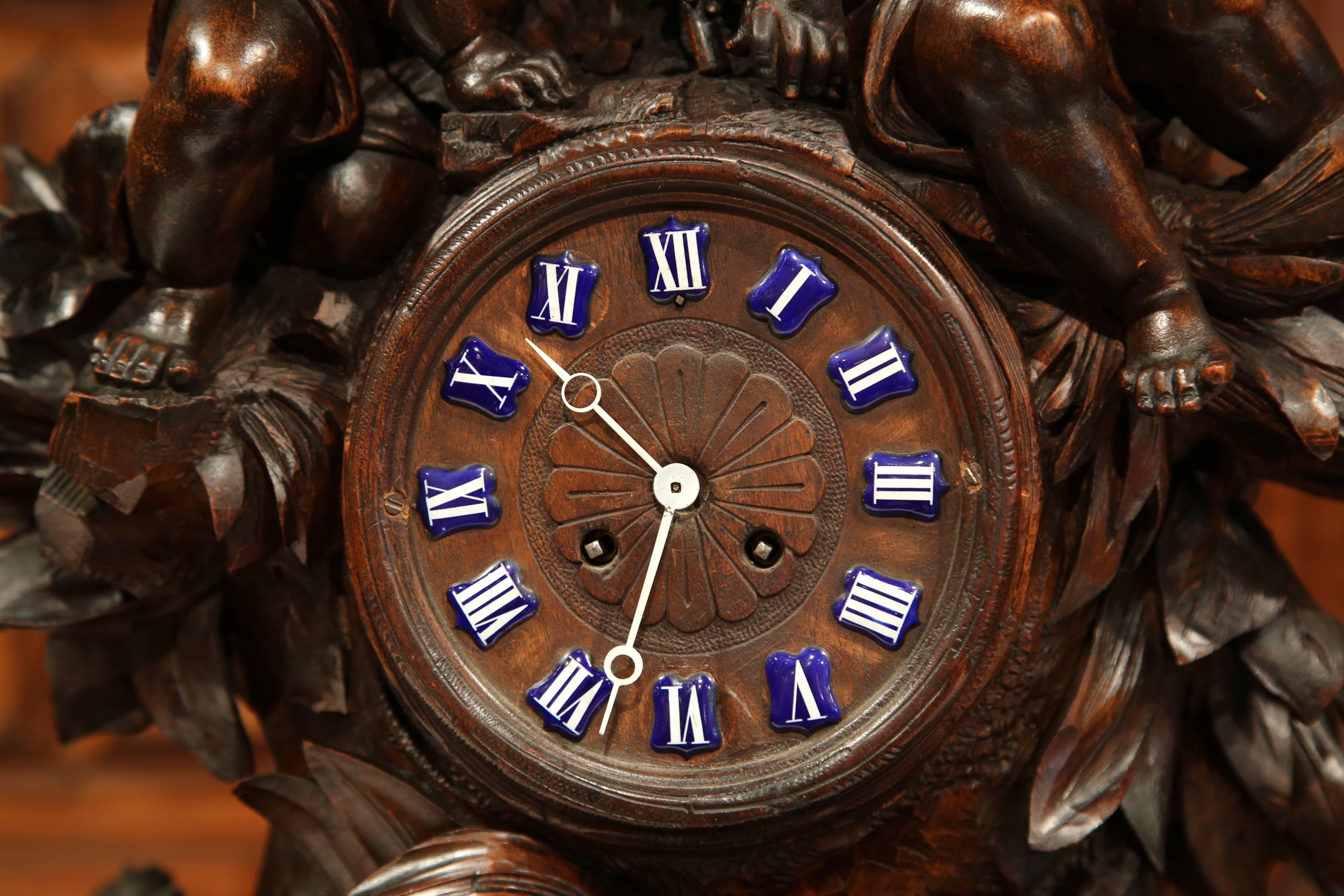 Enamel 19th Century Swiss Black Forest Carved Walnut Mantel Clock with Cherubs and Bird For Sale