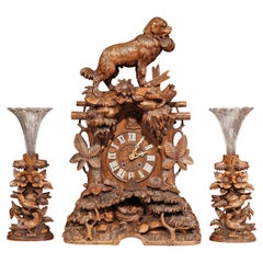 19th Century Swiss Black Forest Carved Walnut Three-Piece Mantel Clock Set