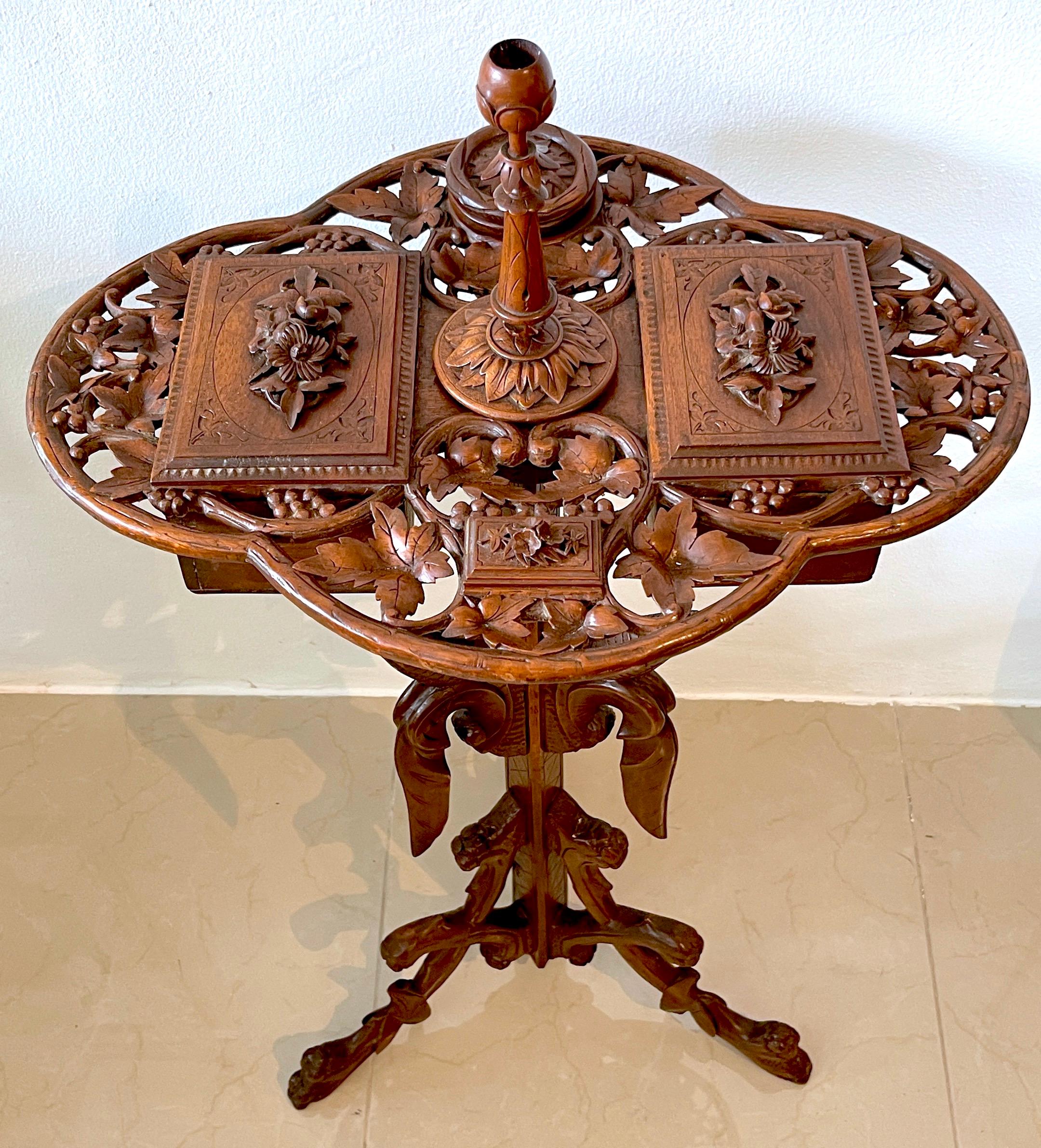 19th century Swiss black Forrest carved walnut smoking stand- complete
Switzerland, Circa 1880s
An amazing example, with all its orignal pieces. The oval intricately hand-carved and pierced walnut trellis top, with all over floral and leaf motifs.