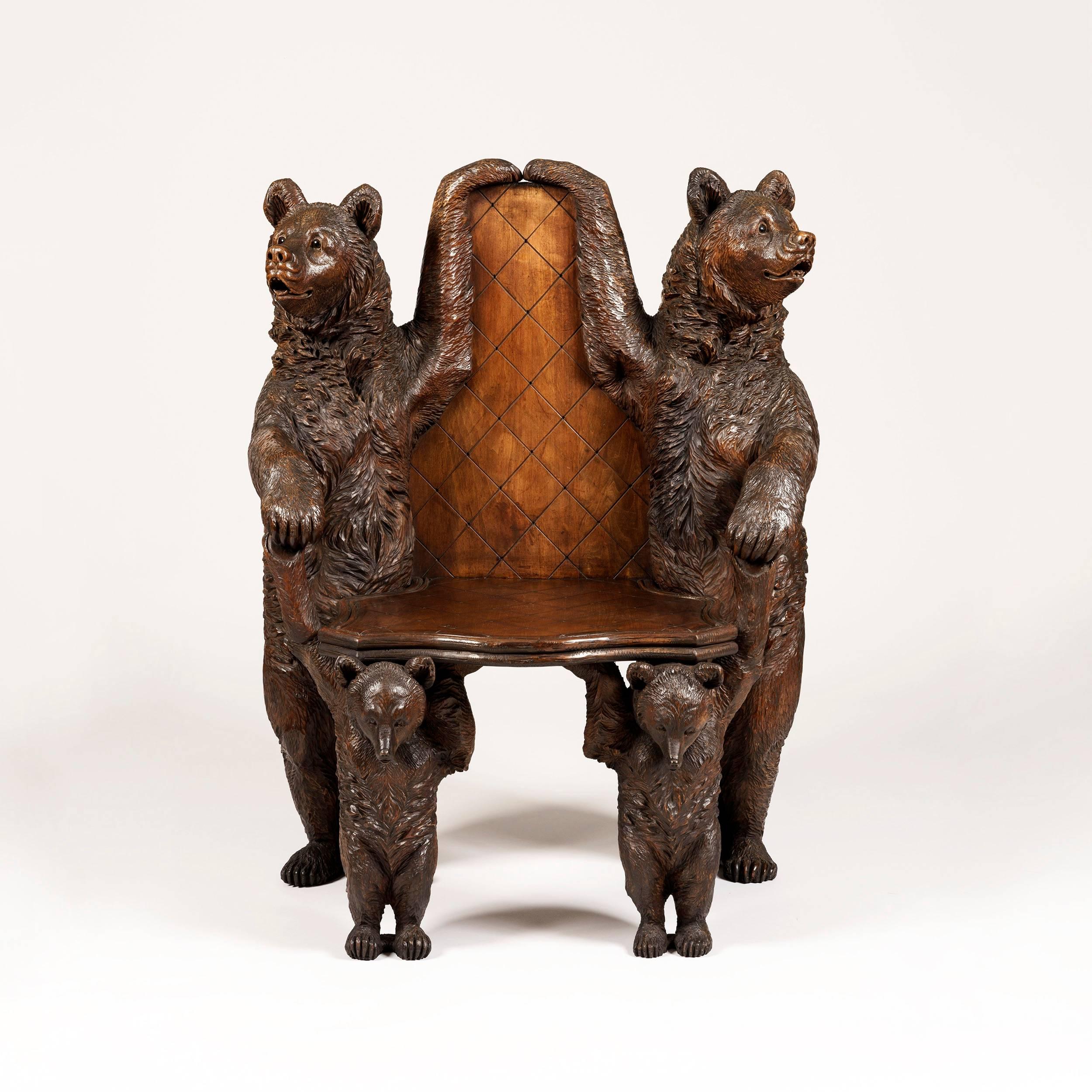 An unusual 'Black Forest' bear seat

Constructed in lindenwood and having realistic glass eyes; two addorsed adult bears stand to the rear, each having an arm uplifted linked to outline the shaped hatched back, and the other arms providing the