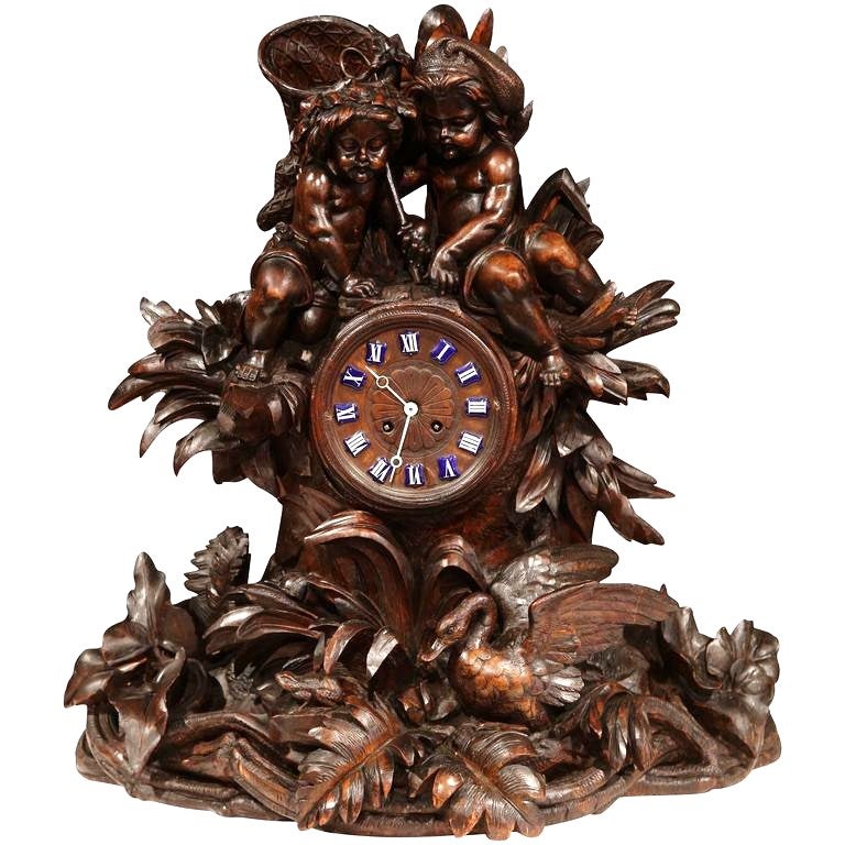 19th Century Swiss Carved Walnut Clock with Cherubs and Animal Motifs