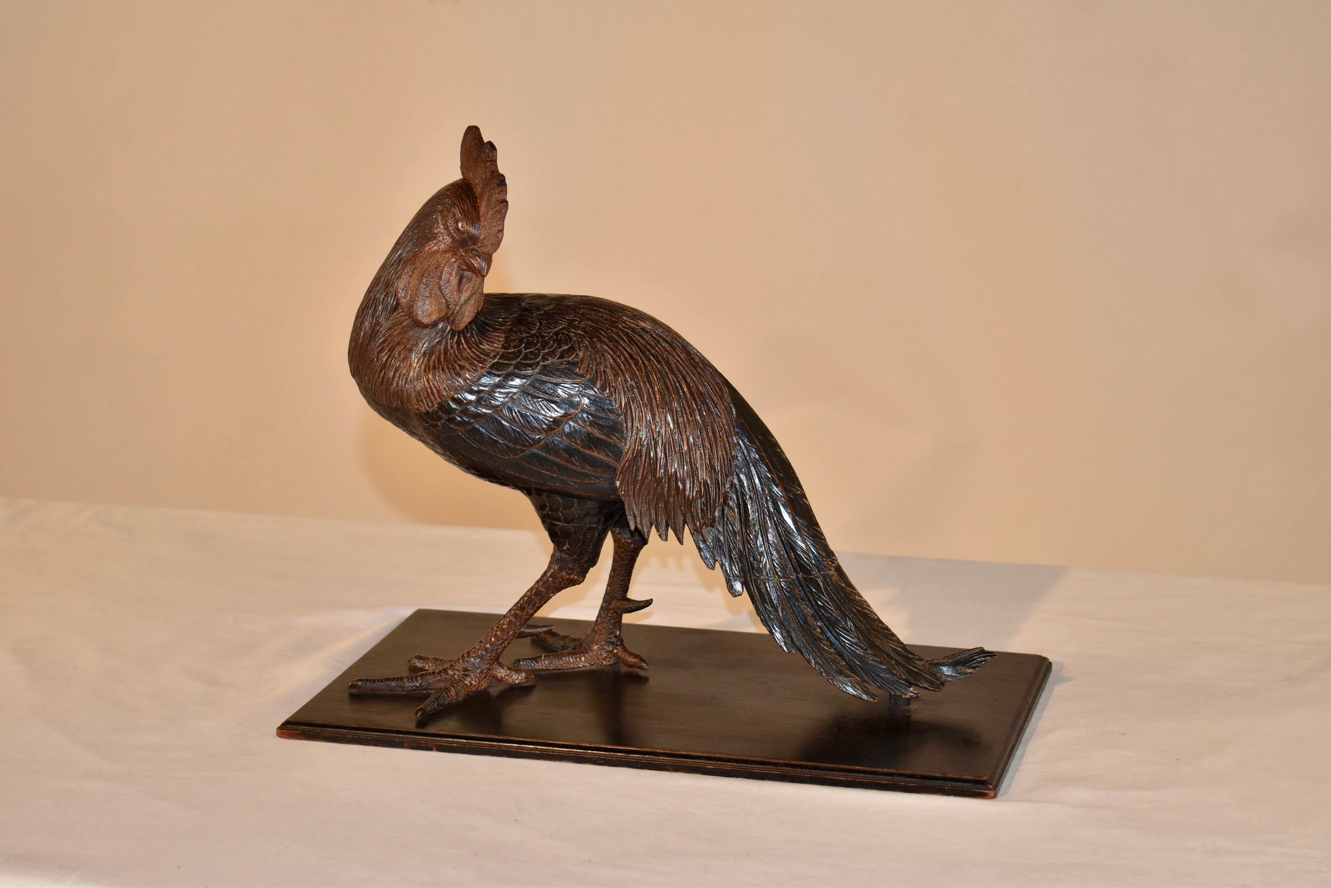 19th century fine Swiss carving of a rooster.  

The rooster has been expertly hand carved and polychromed for added color and detail.  The rooster's comb and wattles are pronounced, as are all of his feathers for added interest to the carving.  The