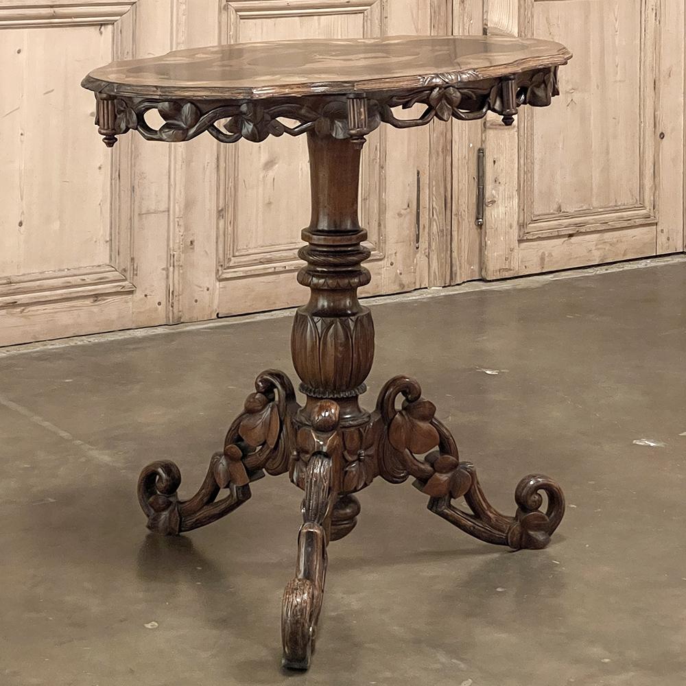 19th century Swiss inlaid tilt-top center table is a fascinating work of art in wood, crafted by master artisans to be a miniature showcase piece for all to admire! The marquetry on the top is amazing, with a stag and doe in silhouette on an