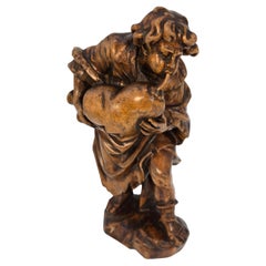 19th century Swiss limewood carving of a man playing an instrument circa 1880