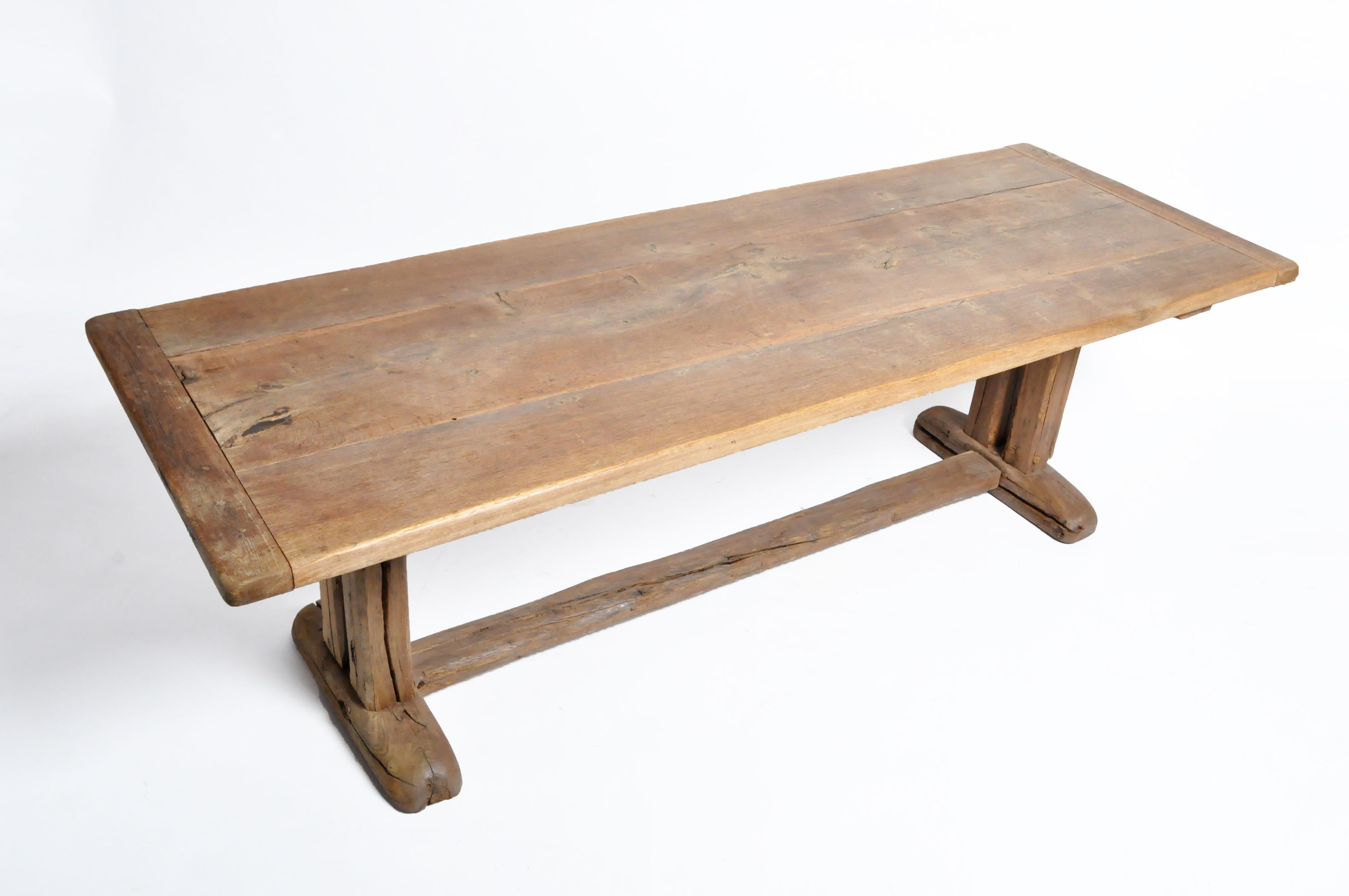 This rustic long farm table is from Switzerland and was made from oak wood, circa mid-19th century. The table features a finely age and beautiful patina. The table can be used as a work table, farm table, dining table, or conference table. Wear