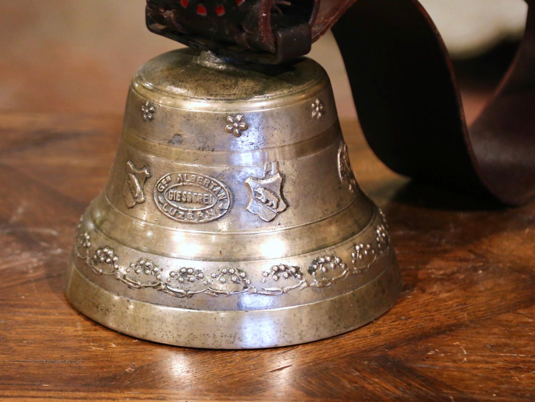 Bring the Swiss countryside into your home with this large antique bell and collar. Crafted by Giesserei, Luzerne, Switzerland circa 1880, the elegant bronze bell features several motifs in relief including floral medallions around the top, bear