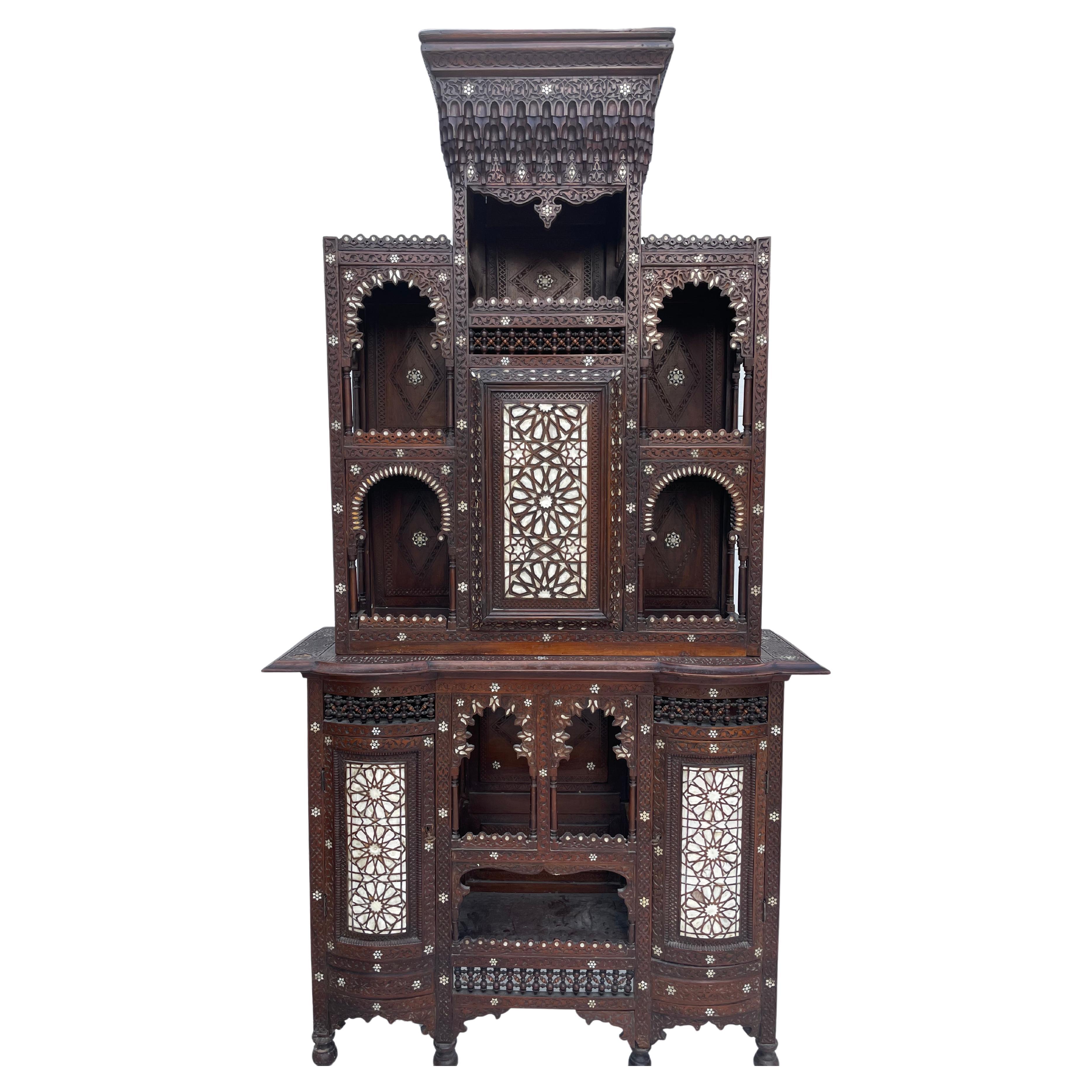 Exeptionel Syrian cabinet from the end of the 19th century. The cabinet is in two parts. Moorish decors has inlay of mother-of-pearl. To be noted, shortages and restorations of the time and age. The cabinet remains spectacular and decorative. Rare