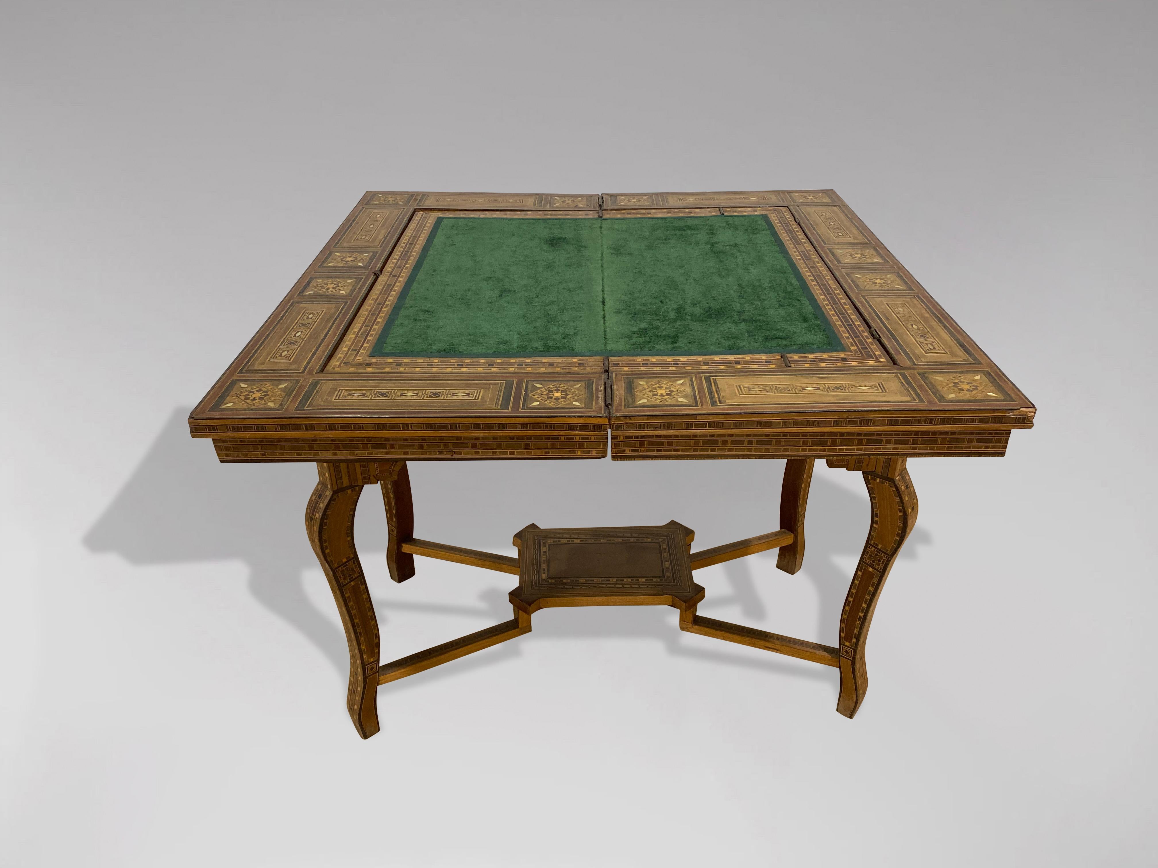 A stunning late 19th century, early 20th century Syrian Damascus marquetry and inlaid games table for cards, chess, draughts and backgammon with inlaid counters. The top swivels and lifts to reveal a green velvet inset playing surface which also